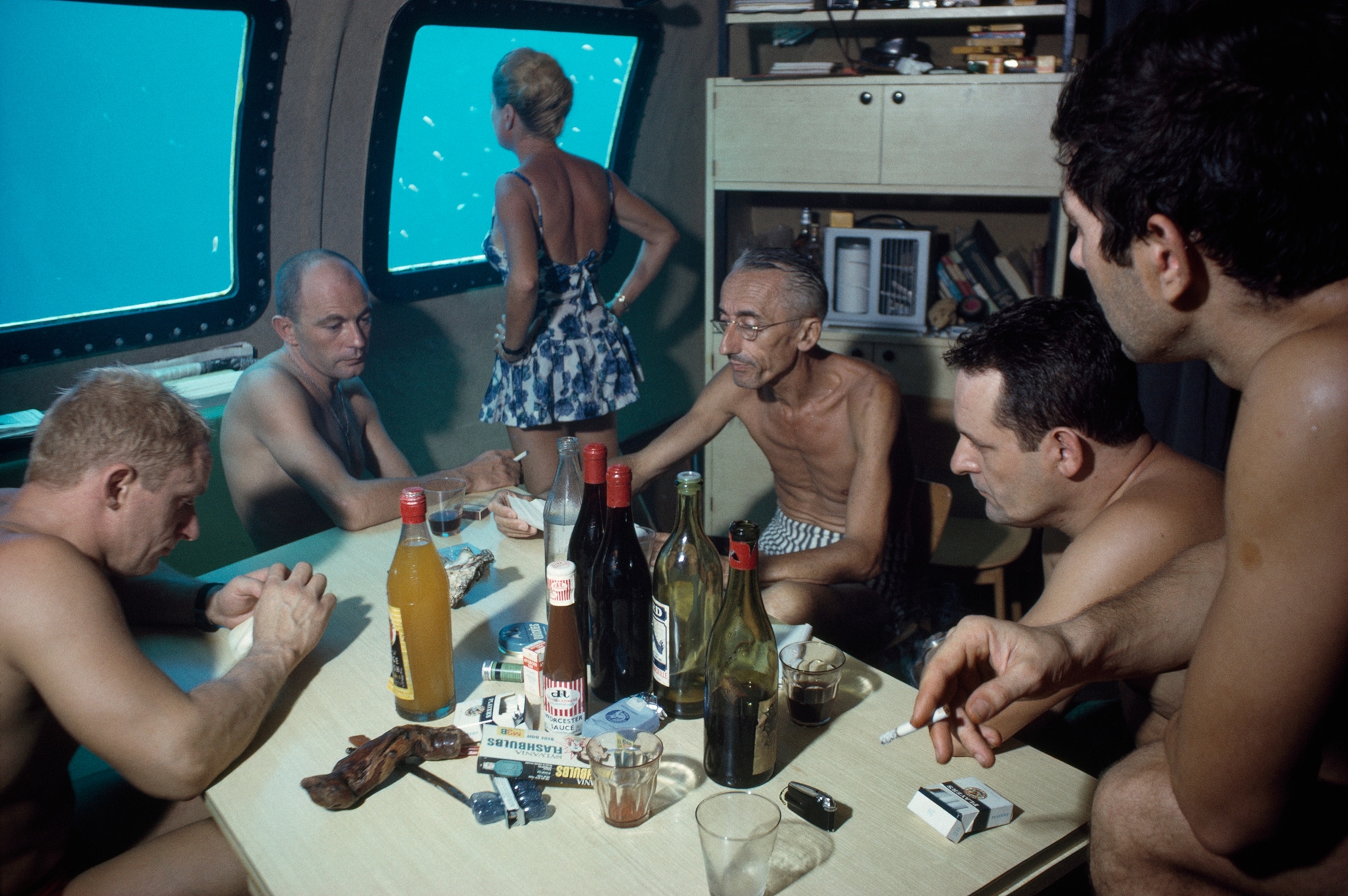The Cousteaus and their crew relax in a submersible after work.