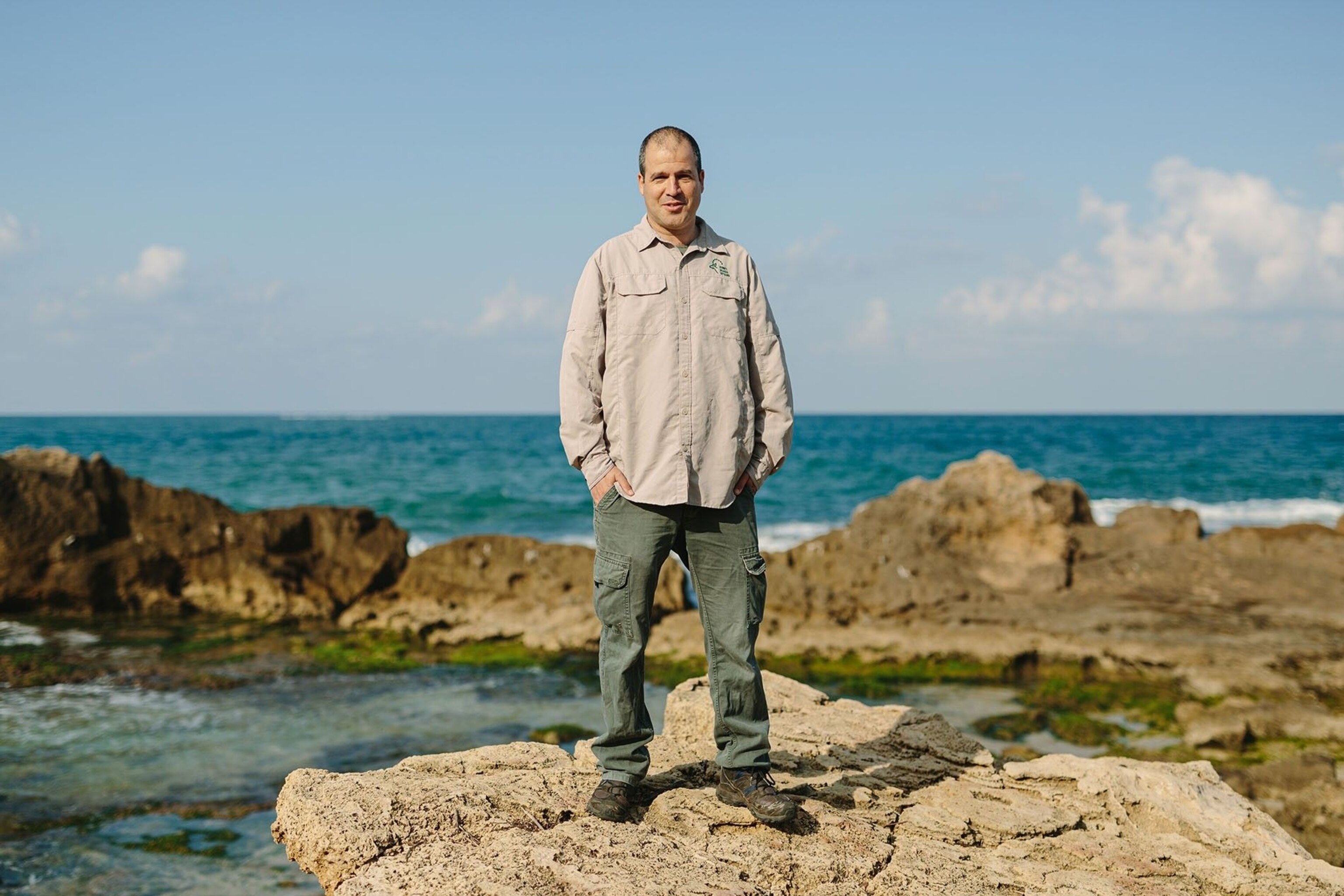Shai Koren, district manager of Upper Galilee Israel Nature and Parks Authority, standing on the Mediterranean shoreline of Achziv National Park.