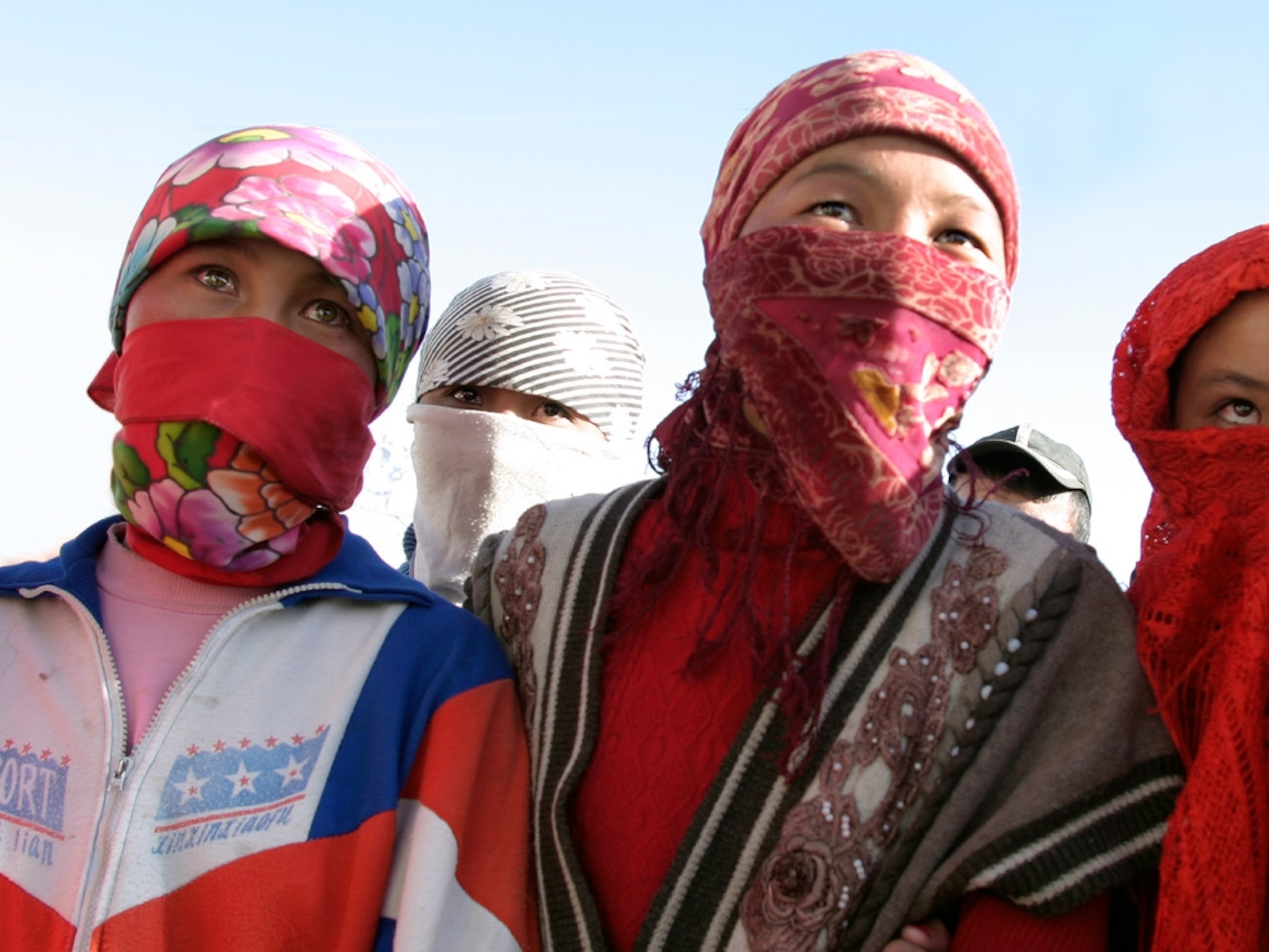 Young women with their faces covered