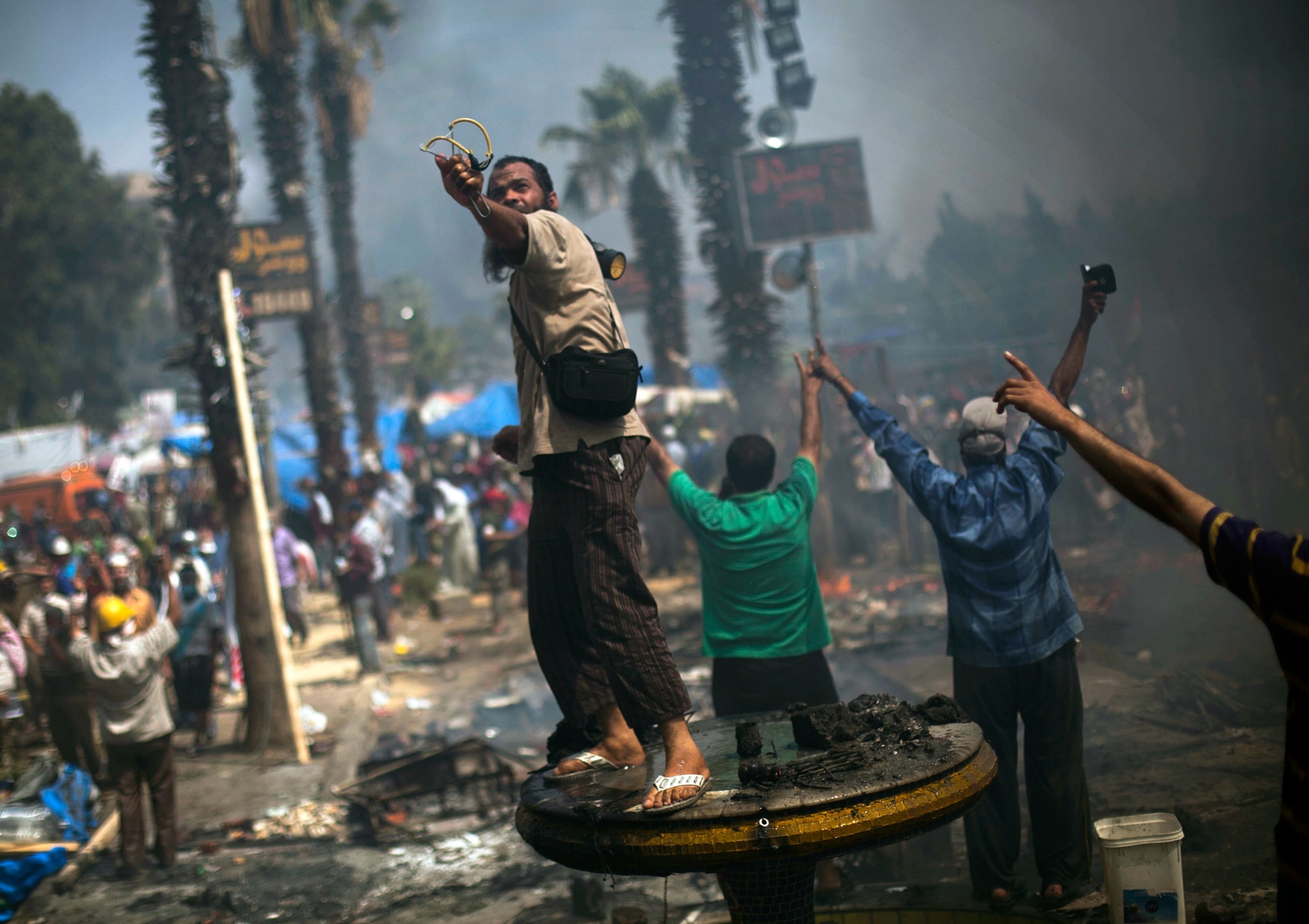 Morsi supporter uses a slingshot.