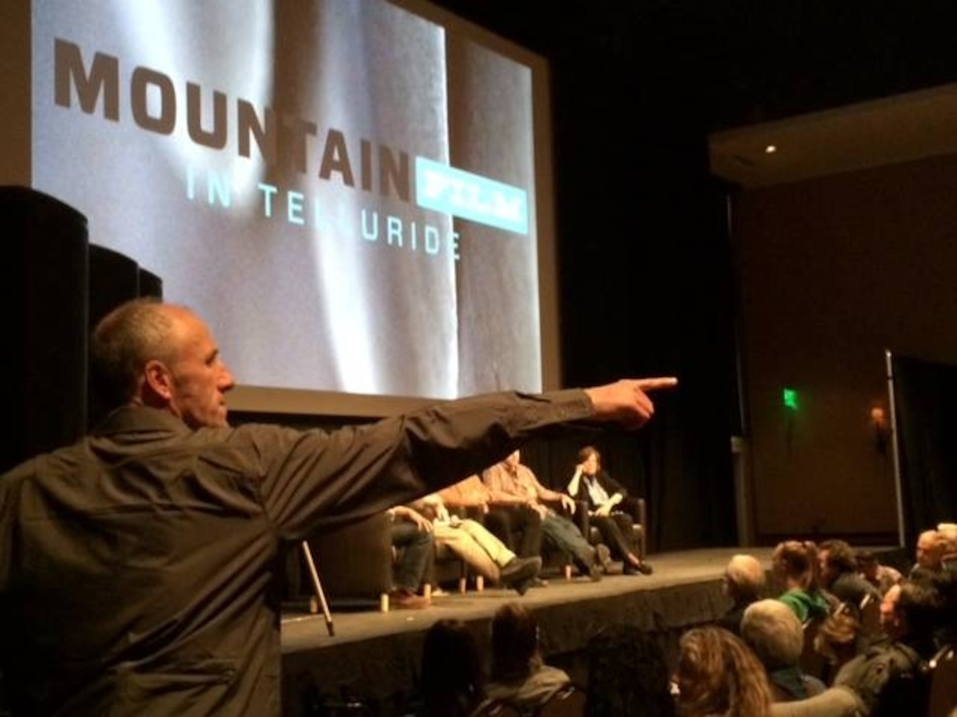 Mountainfilm festival director David Holbrooke spotting people with questions in the audience at the symposium on wilderness.