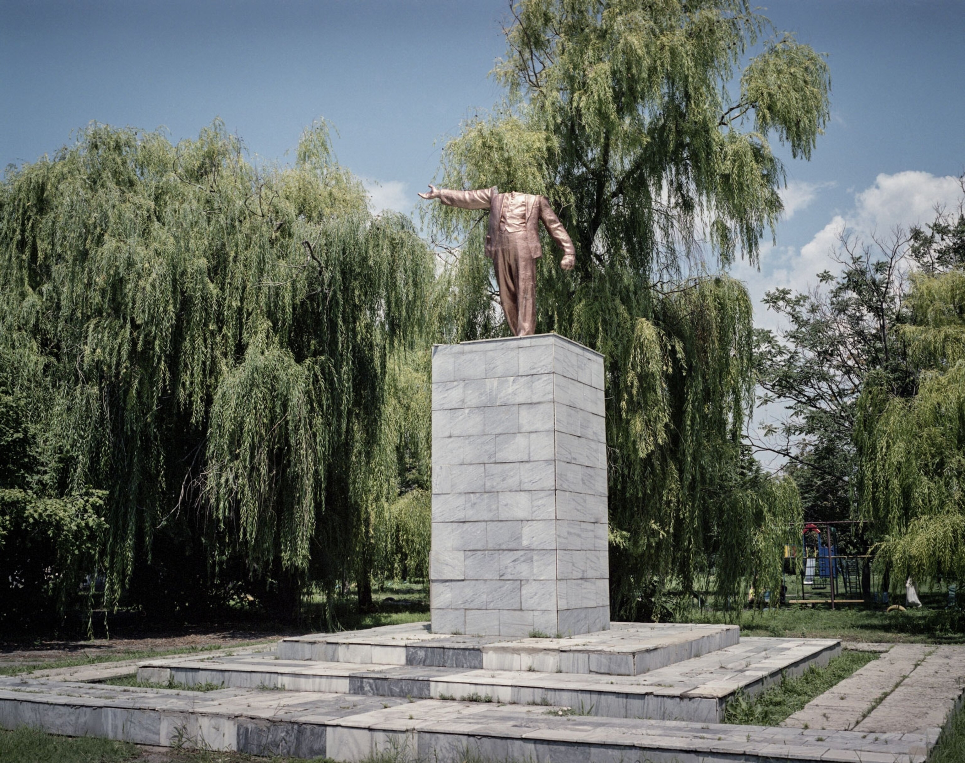 Dniprovka village, 2015. A headless statue of Vladimir Lenin, painted gold, stands in the center of the village on the bank of the Kakhovka Reservoir on the Dnieper river.