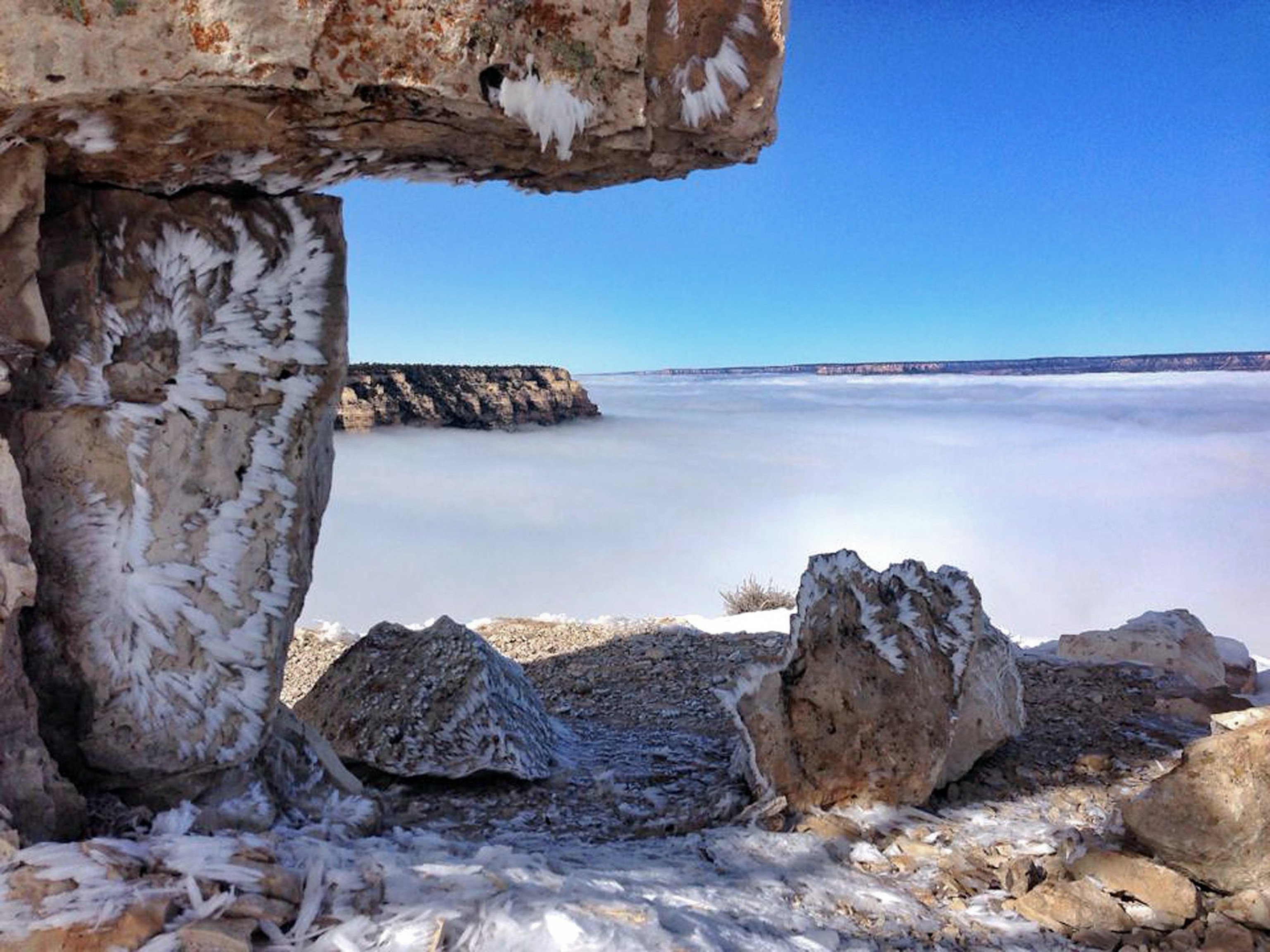 Kaibab Limestone at the Grand Canyon with a fog bank hovering over the canyon.