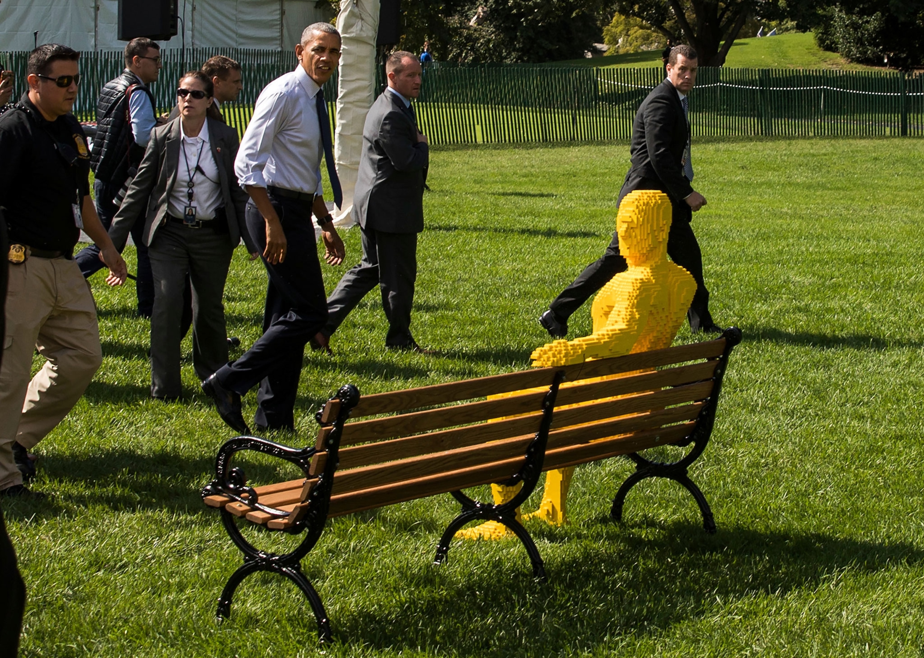 President Obama walking by a sculpture on White House lawn