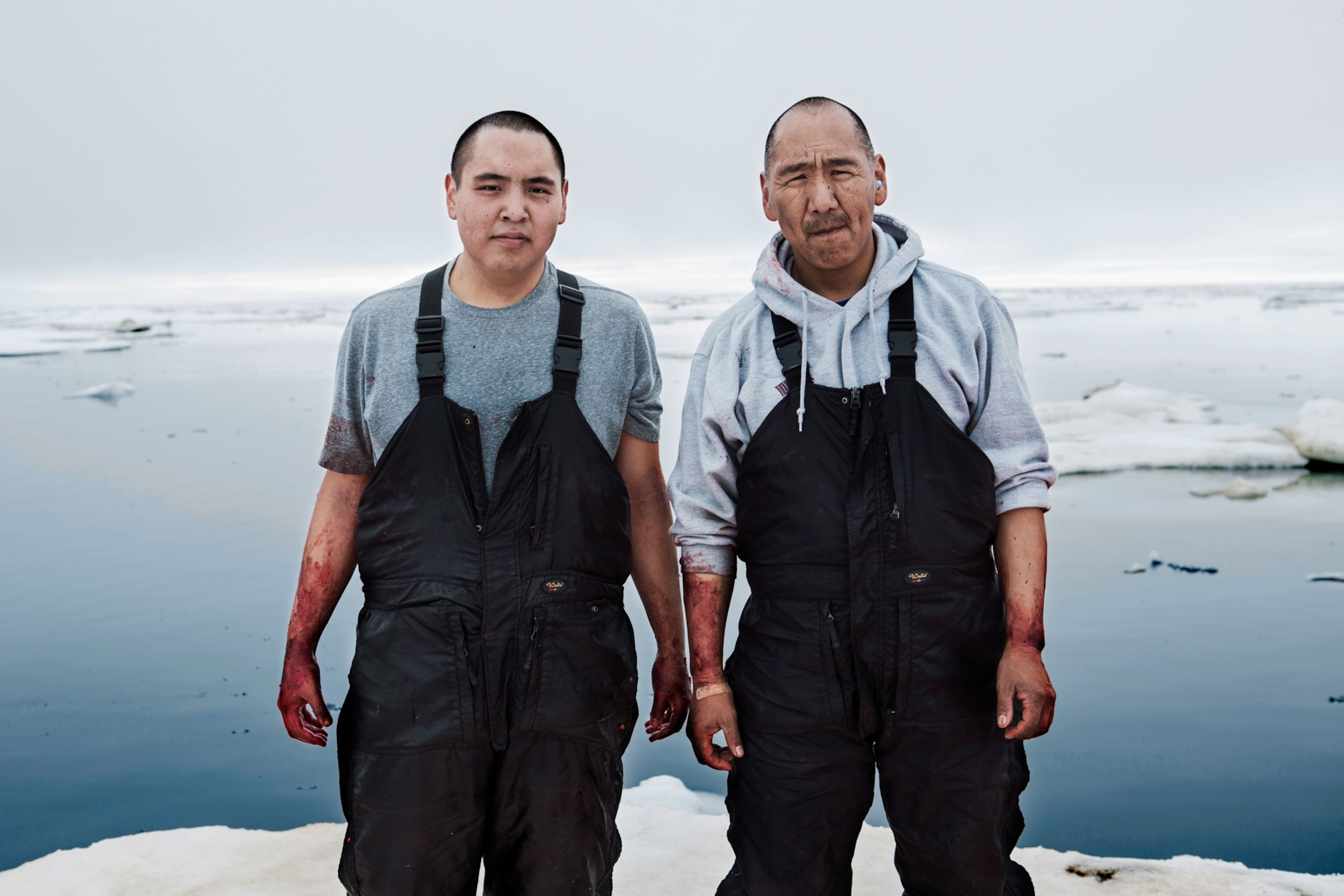 a father and his son after a whale hunt in Alaska