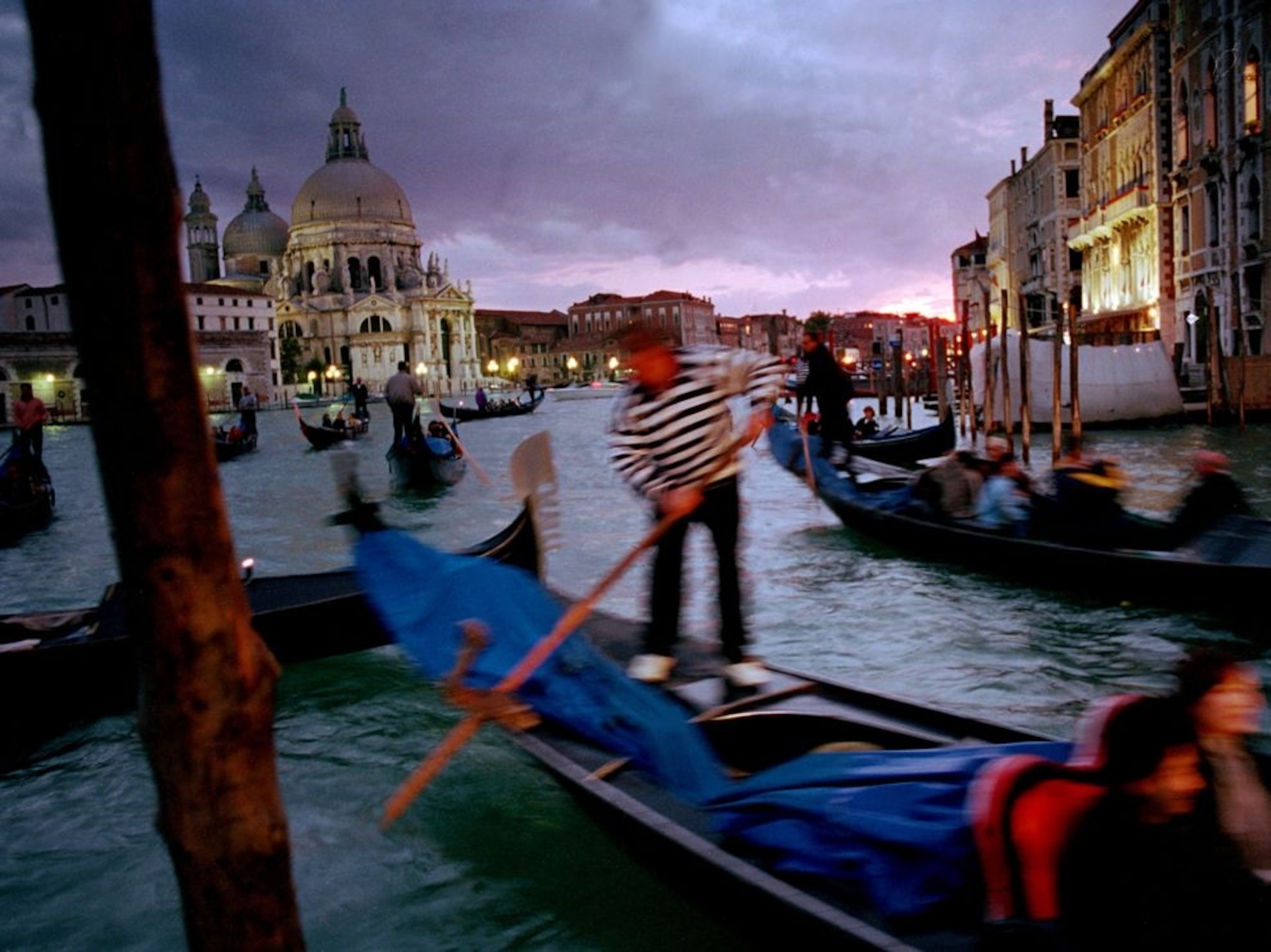 tourists riding gondolas in Venice