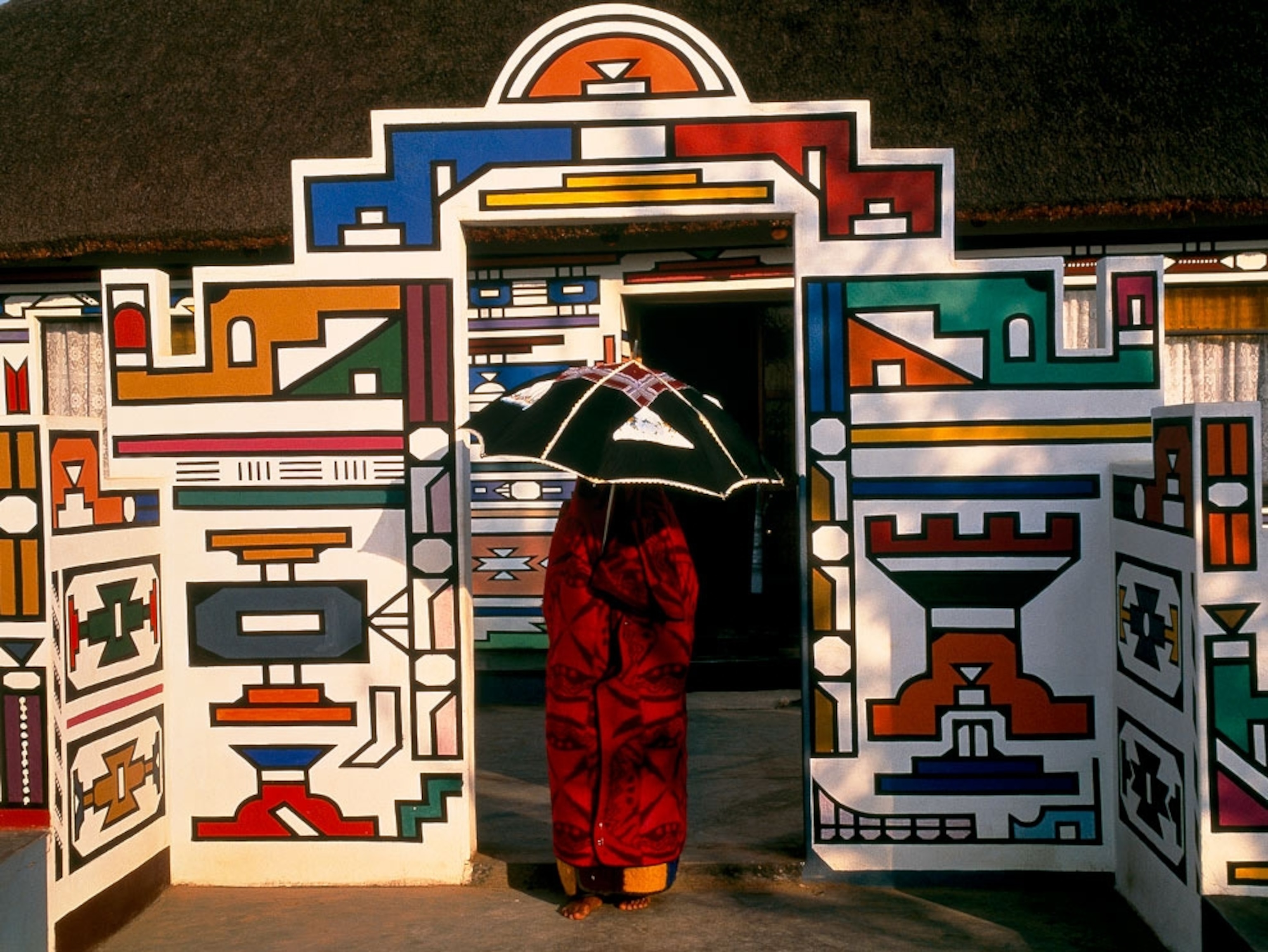 A woman standing in a colorful doorway