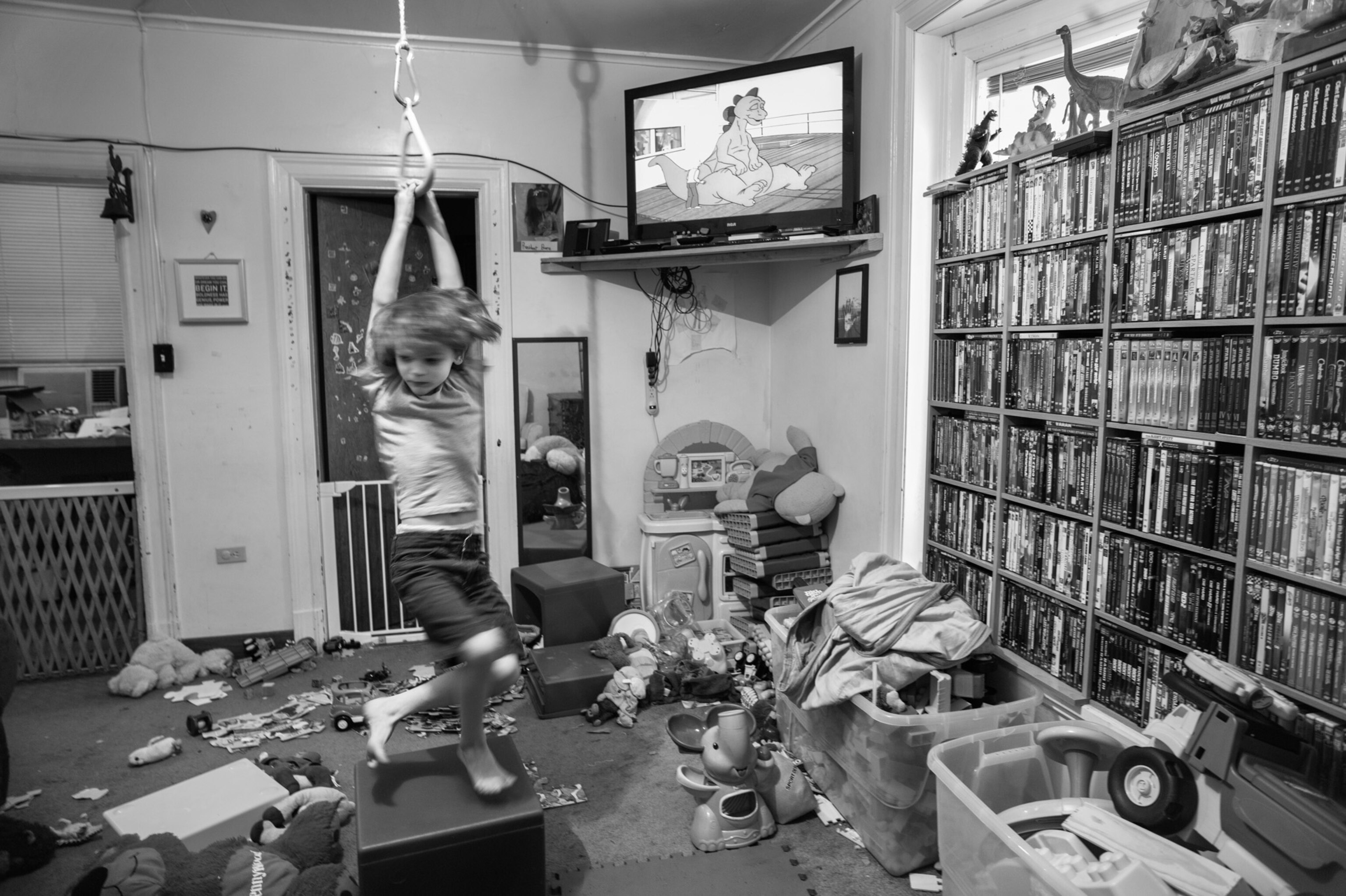 a boy swinging in his playroom
