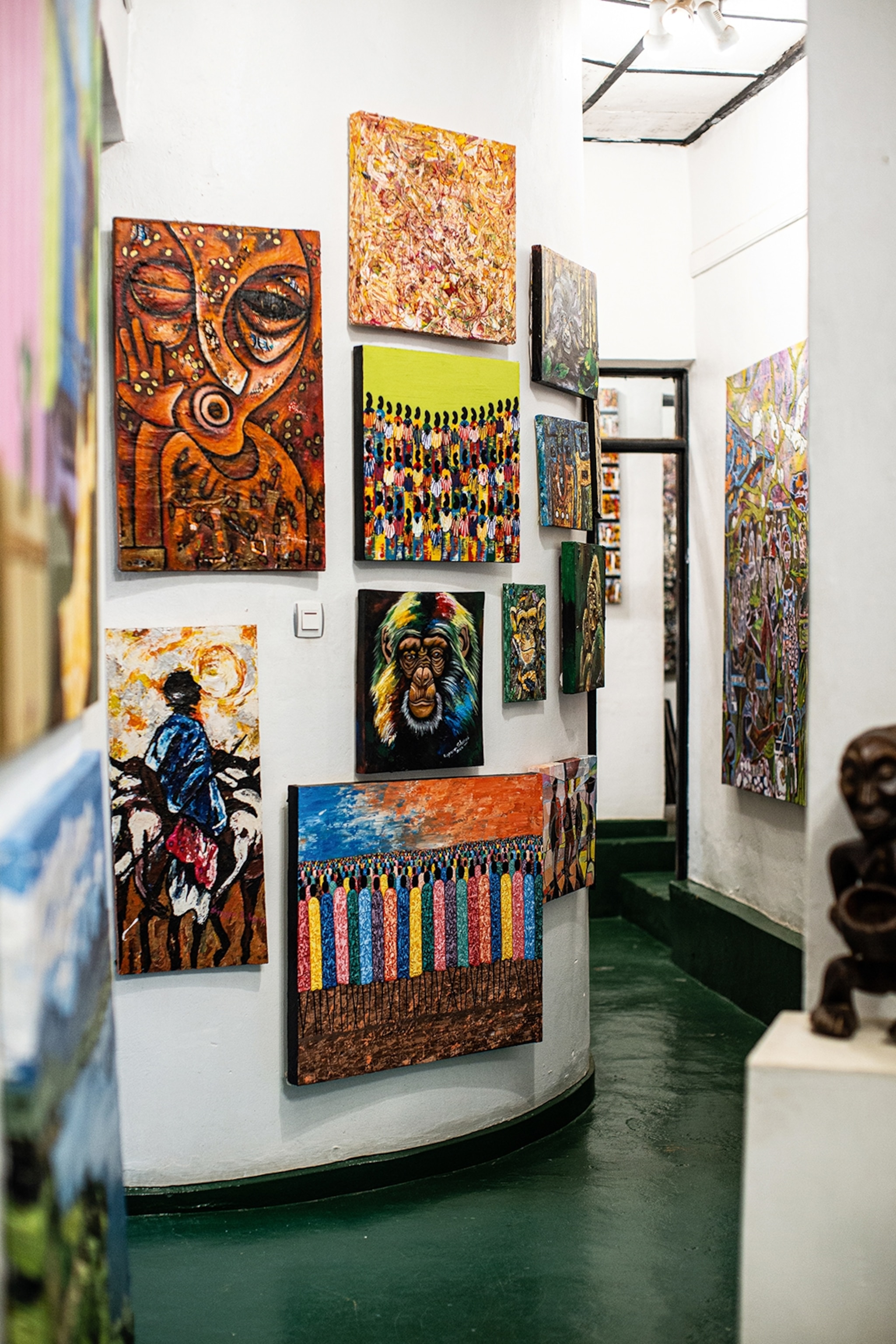 A room in a museum with paintings decorating the walls.