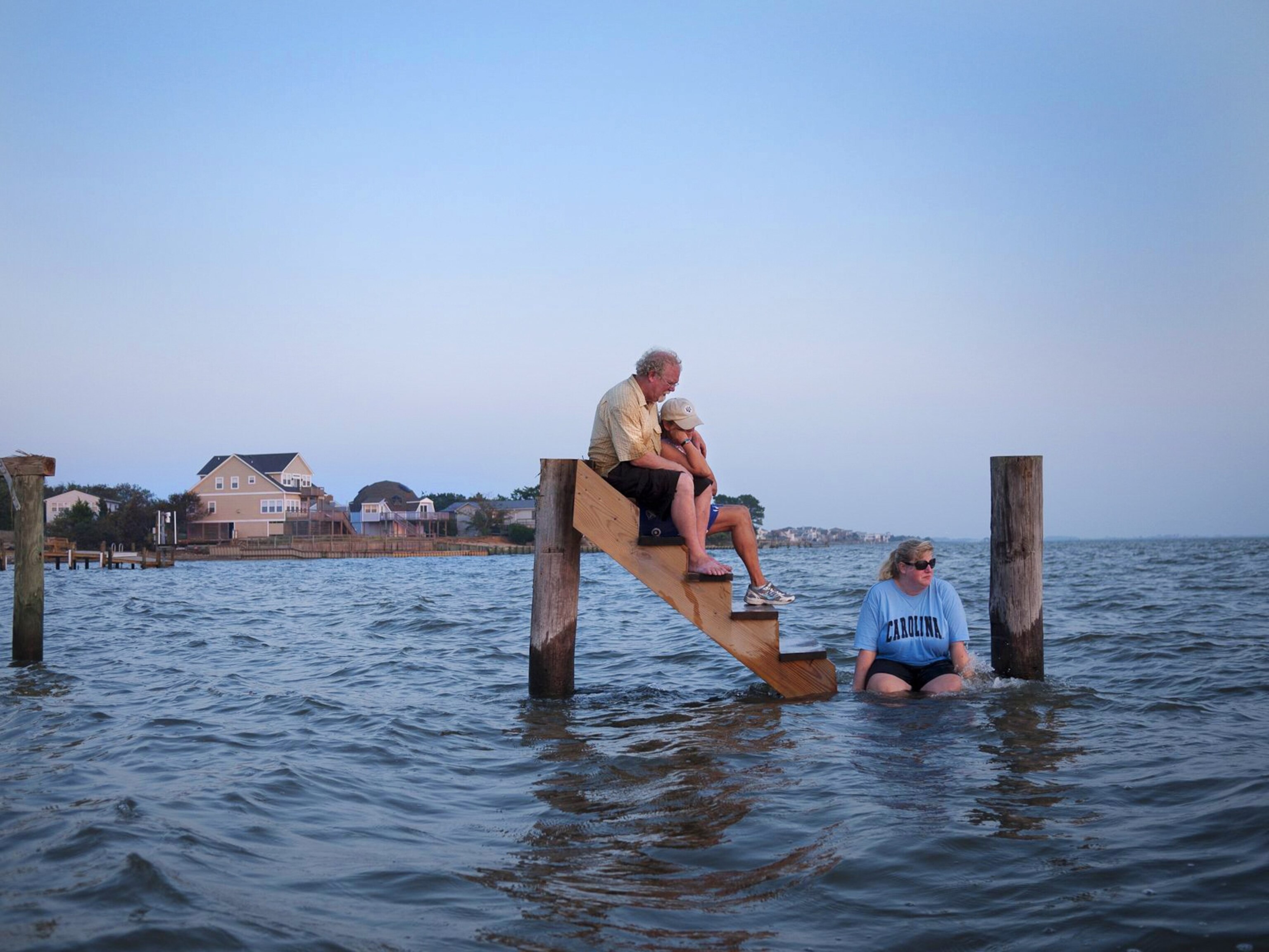the Stinsons sitting on what was left of their beach house after Hurricane Irene