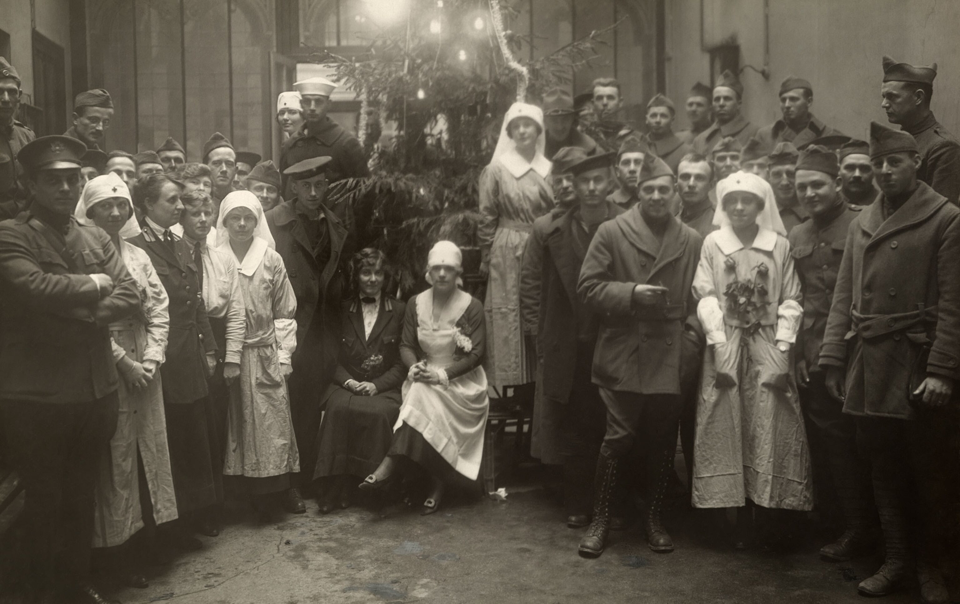 nurses and soldiers posing for a picture together on Christmas