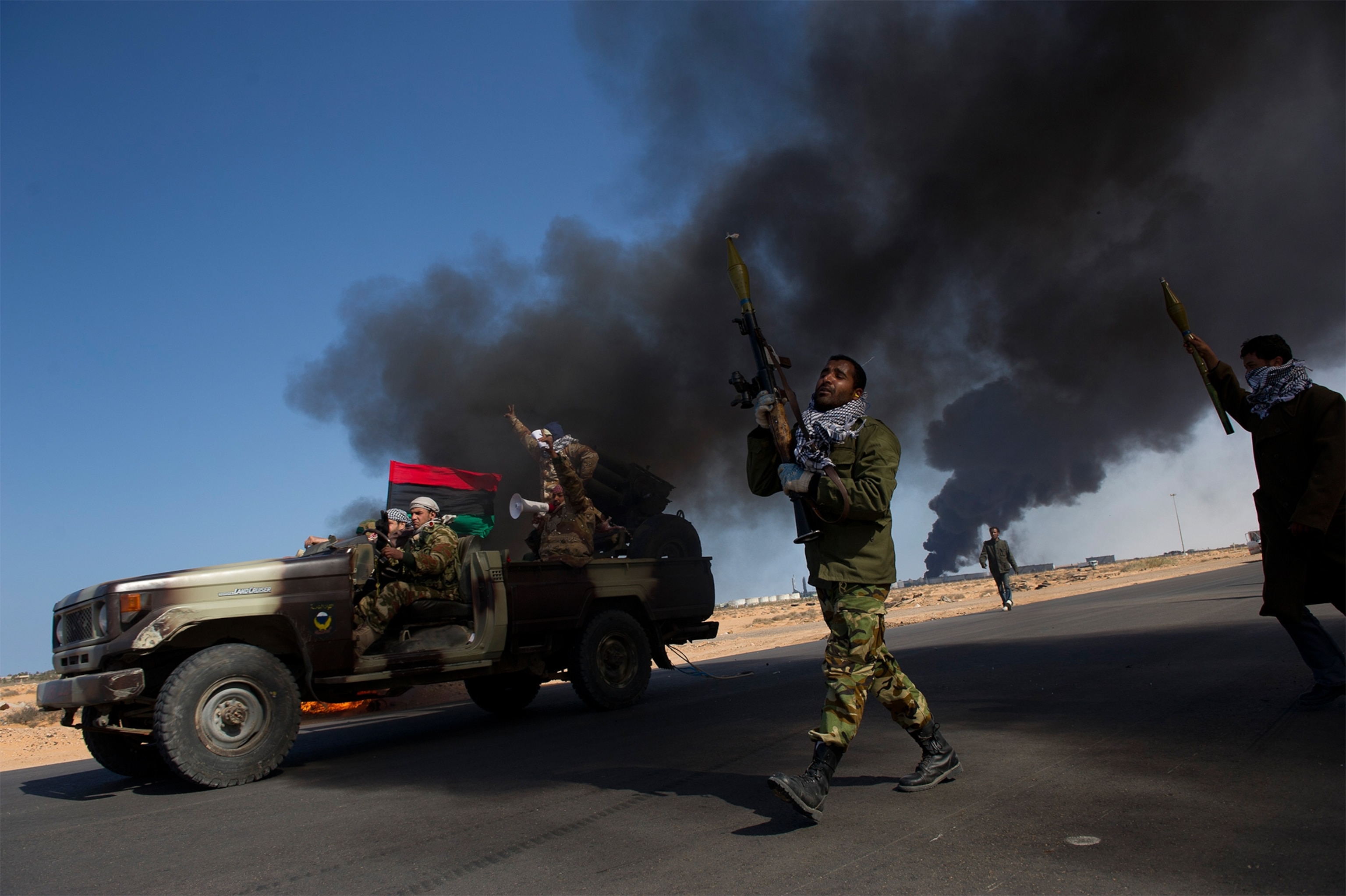 opposition troops burning tired to use as cover during heavy fighting in Eastern Libya