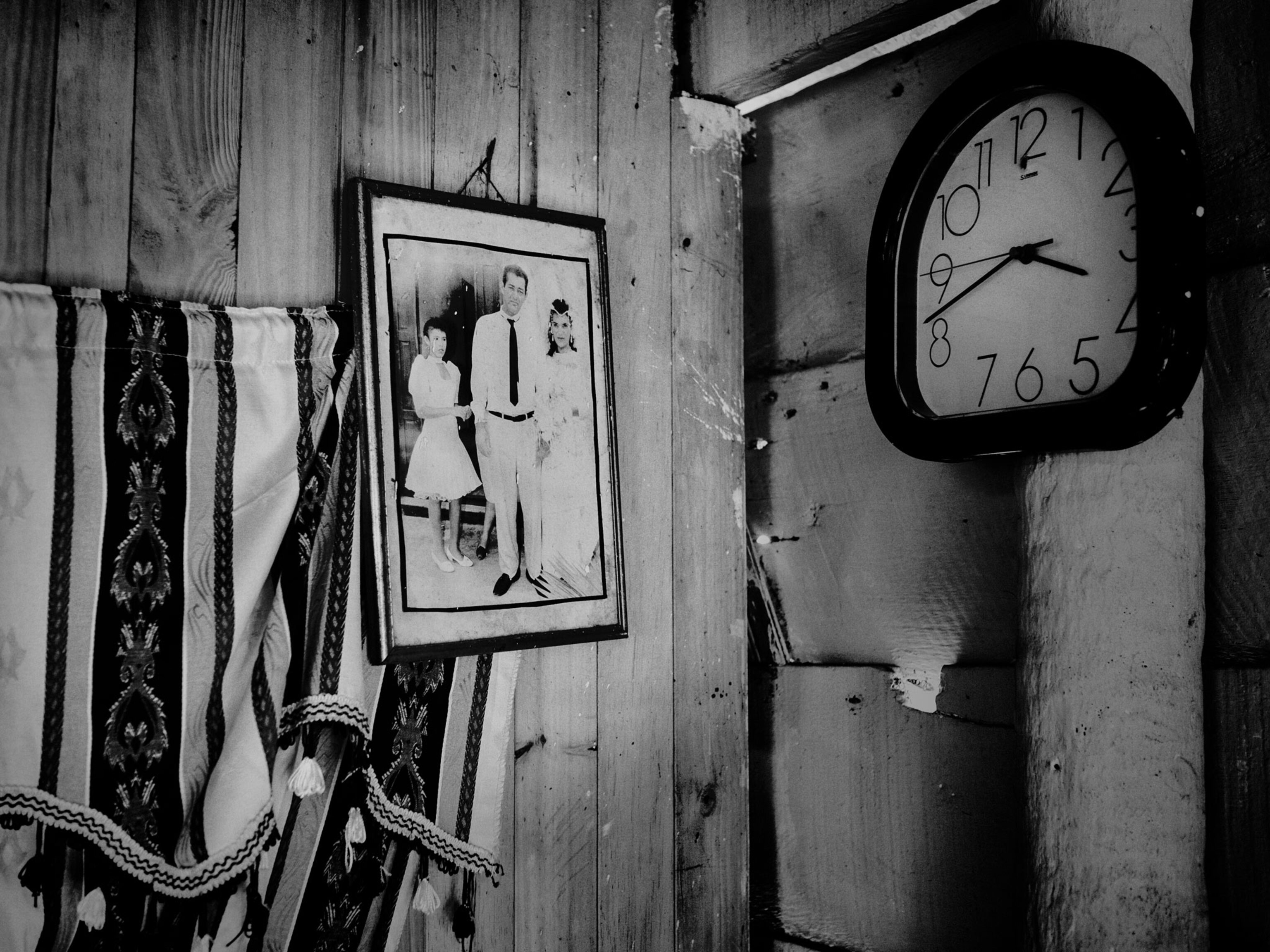 a clock and portrait inside a home in Nueva Venecia, Colombia