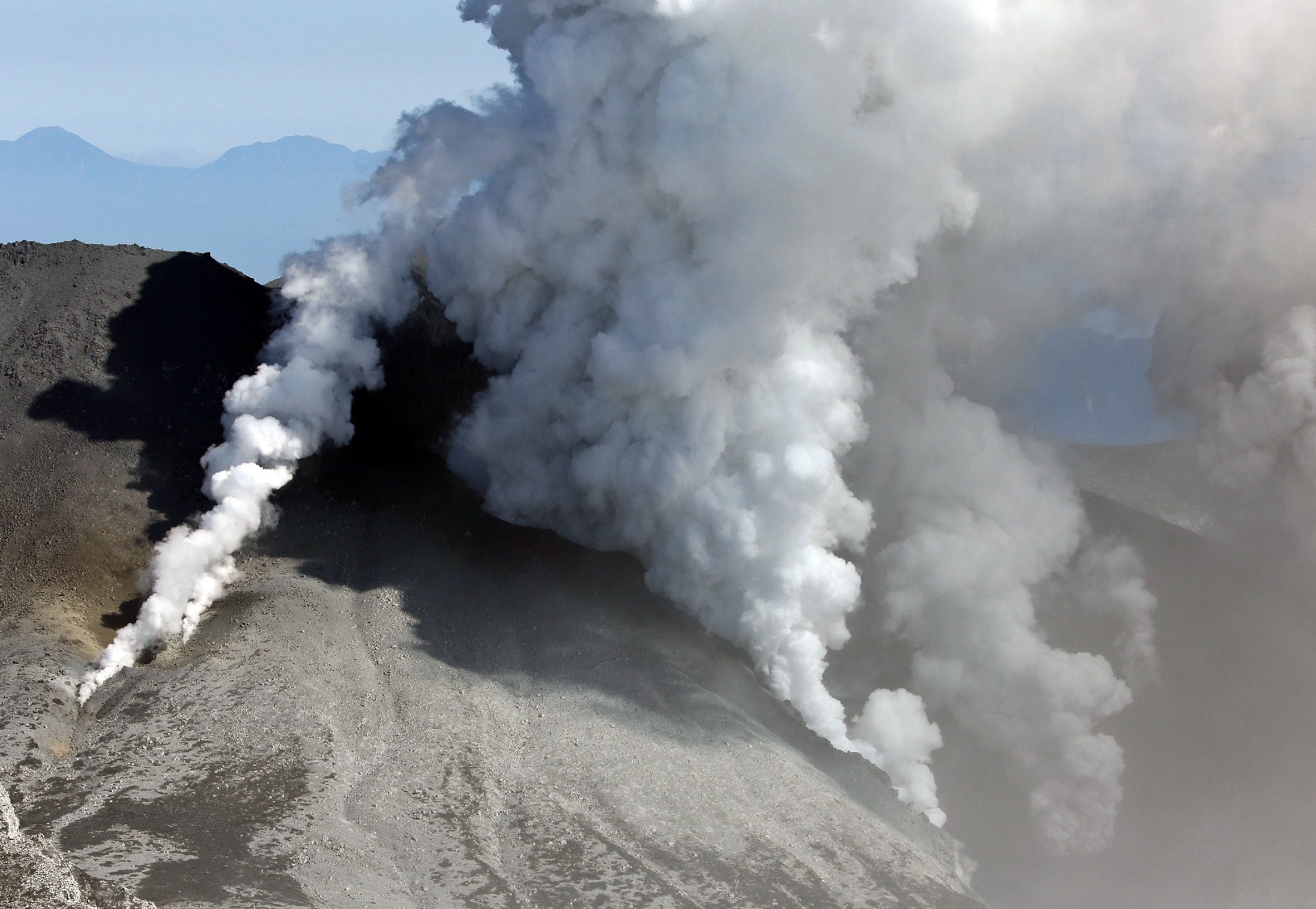 white smokes rising from Mount Ontake.