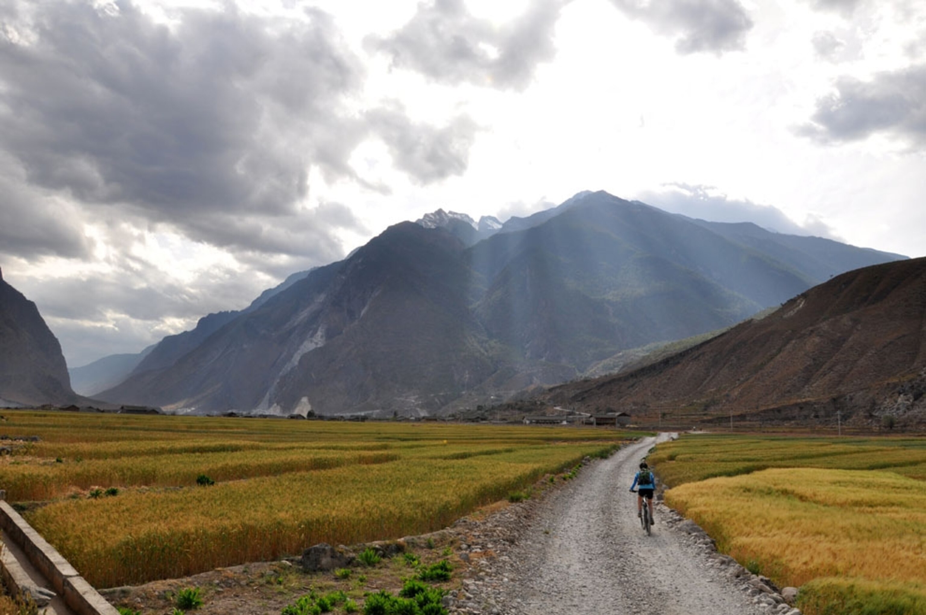 A biker rides along a remote road in China