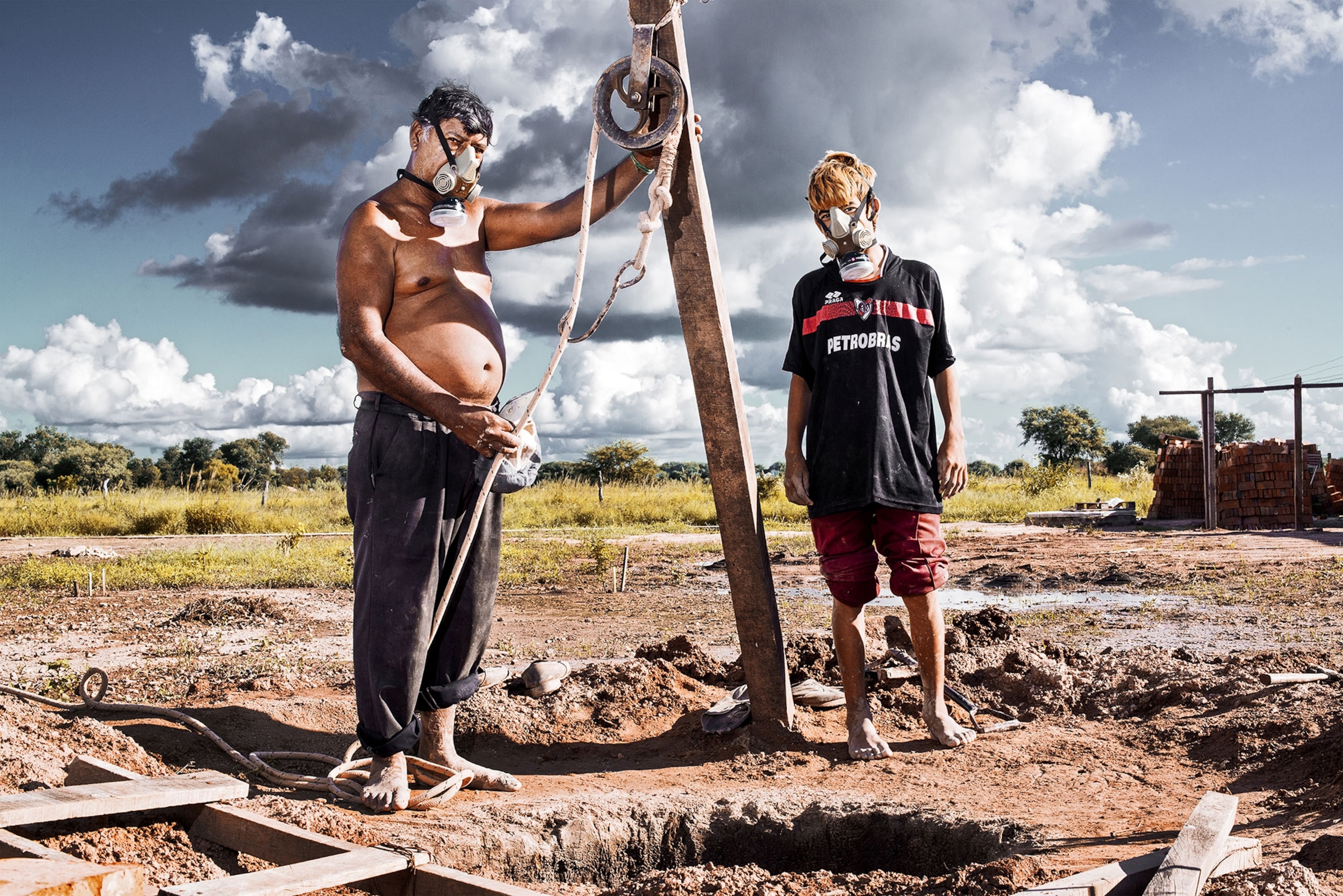man and boy with a water well.