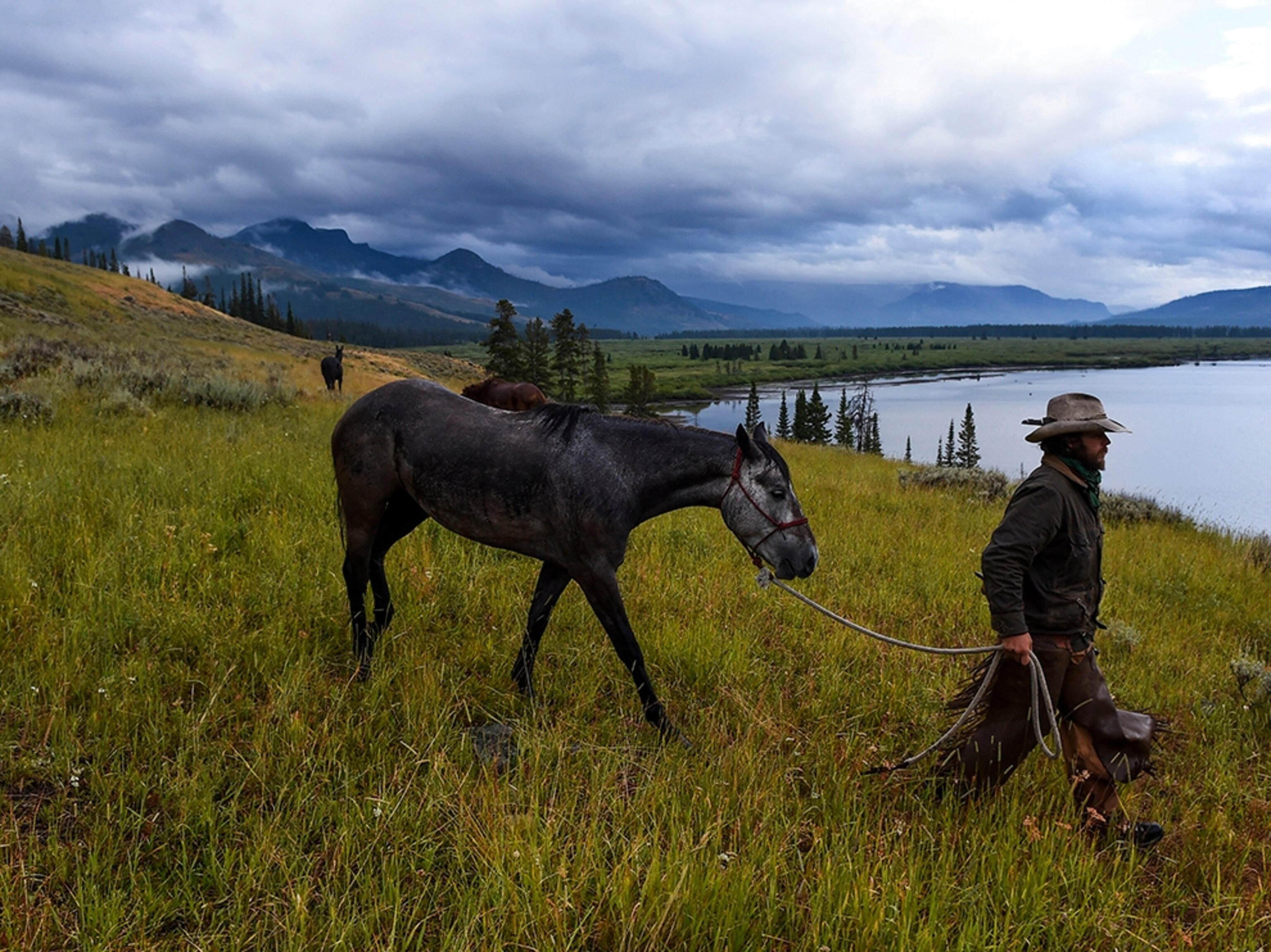Ray Knell saddling his horse.