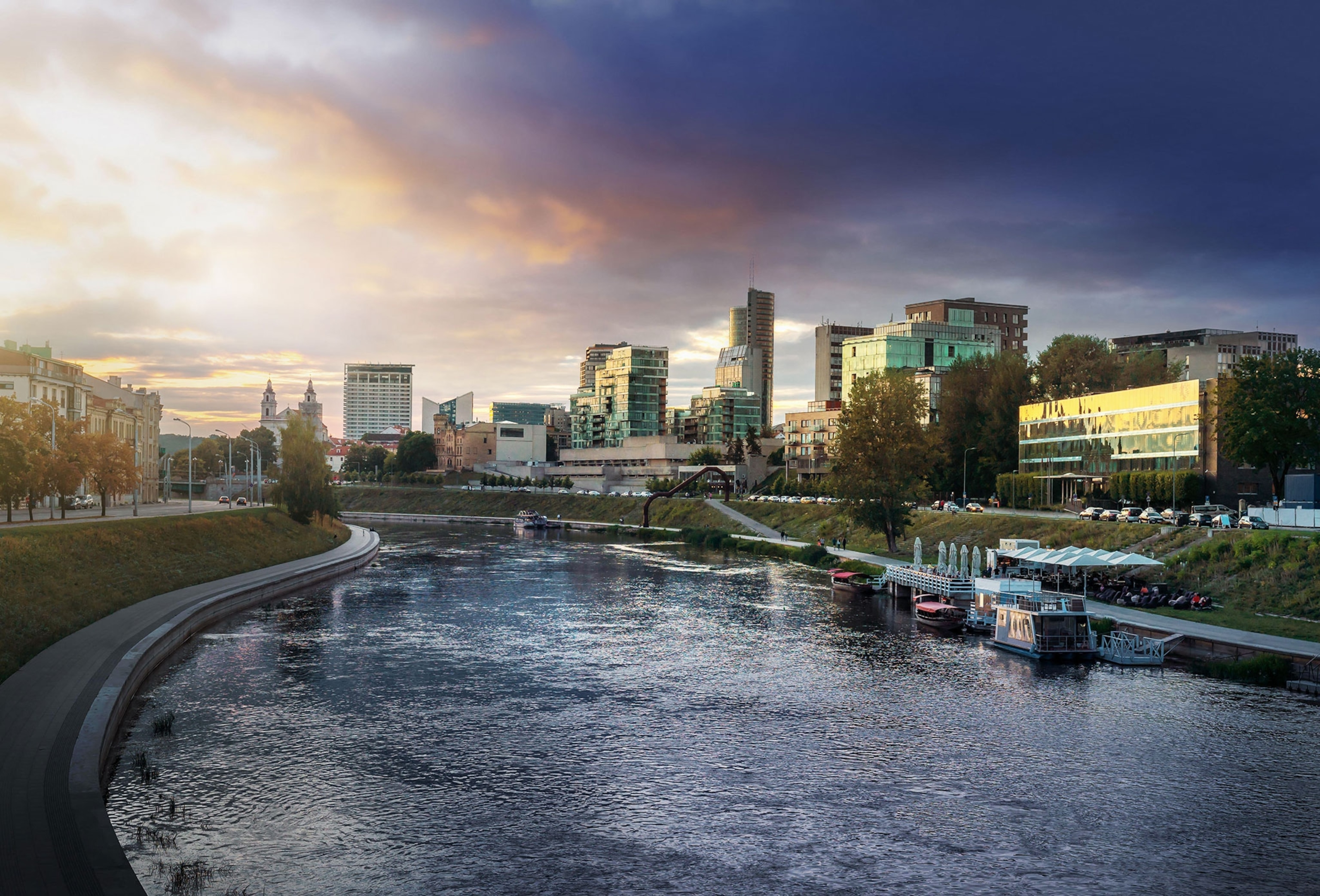Sunset view of Neris River with the modern buildings of the new city center.