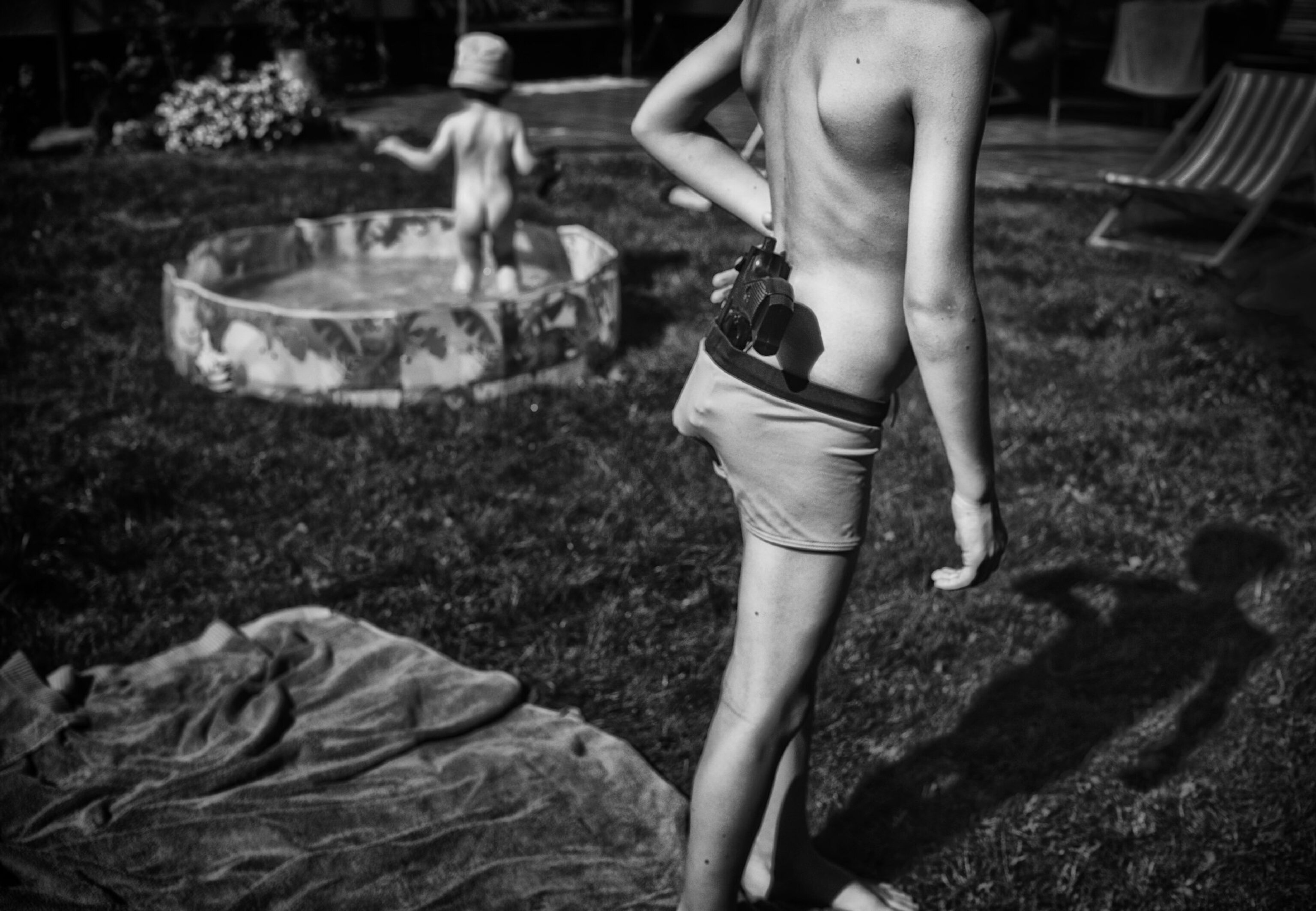 boy with toy guy and baby pool