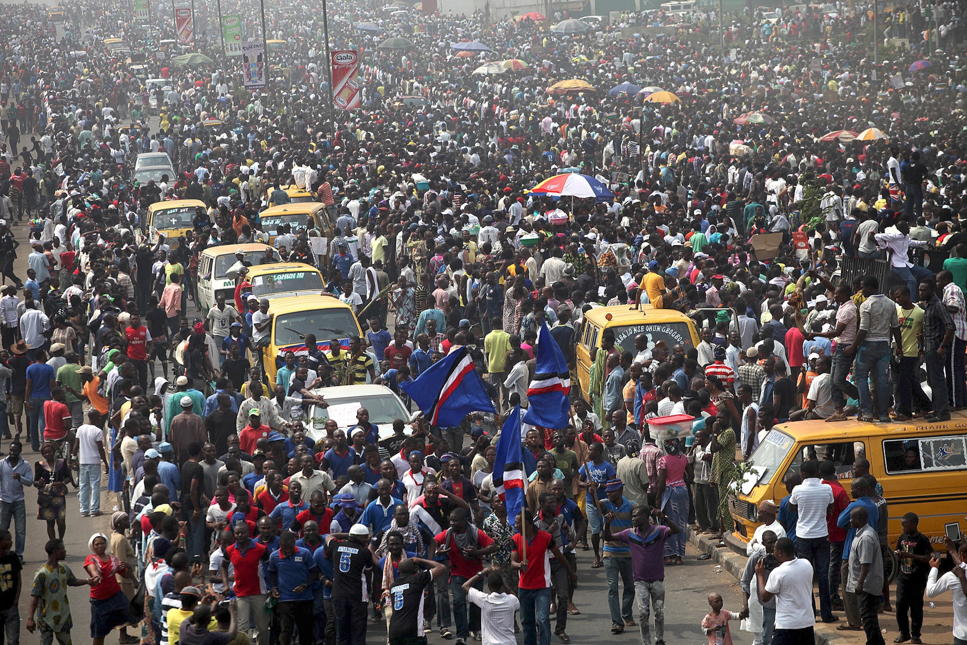 Nigerian black market fuel hawkers look for customers as motorists queue for petrol.