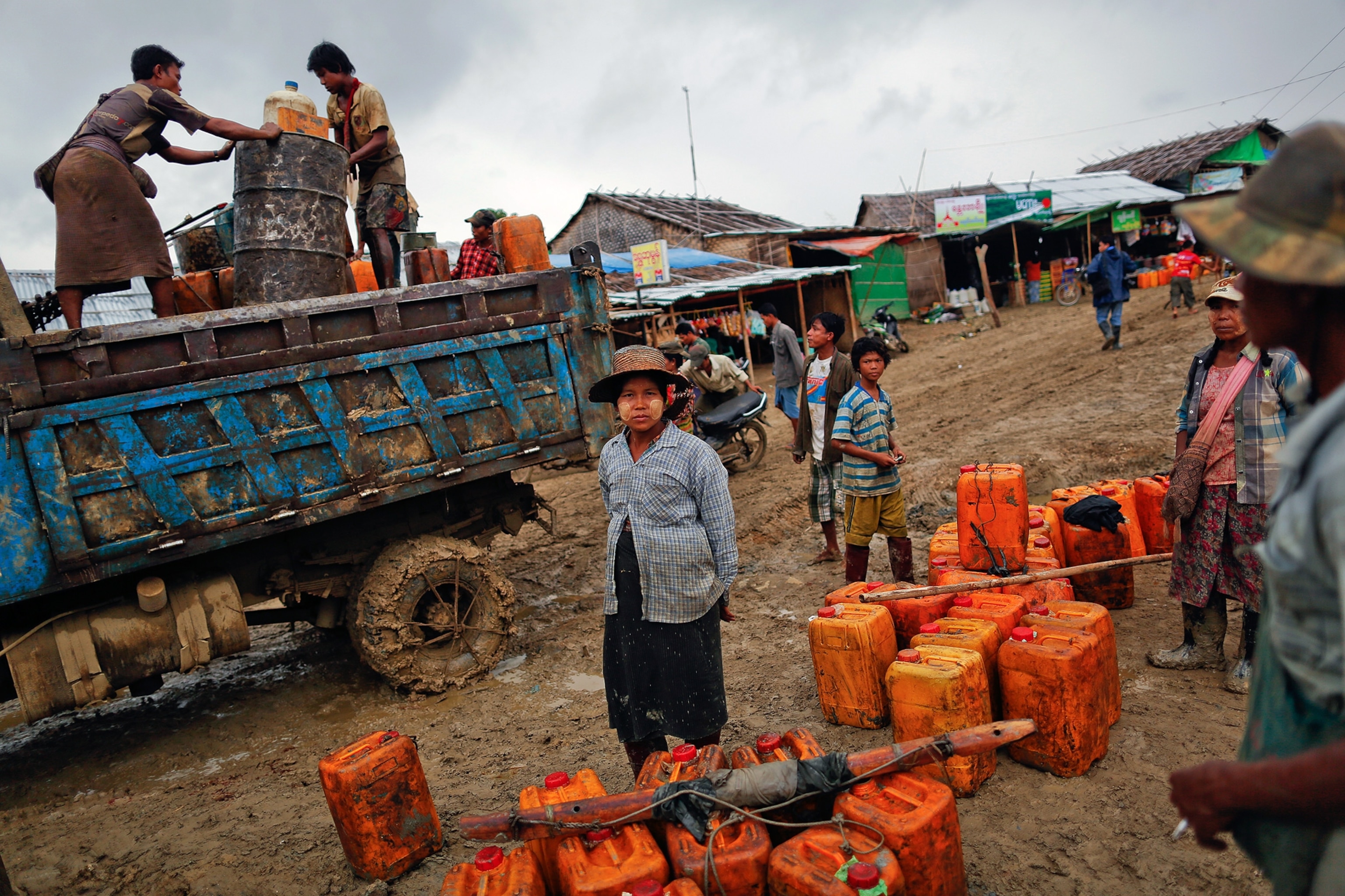 people waiting to sell their crude oil to buyers at an oil field in the Minhla township of the Magwe district in Myanmar.