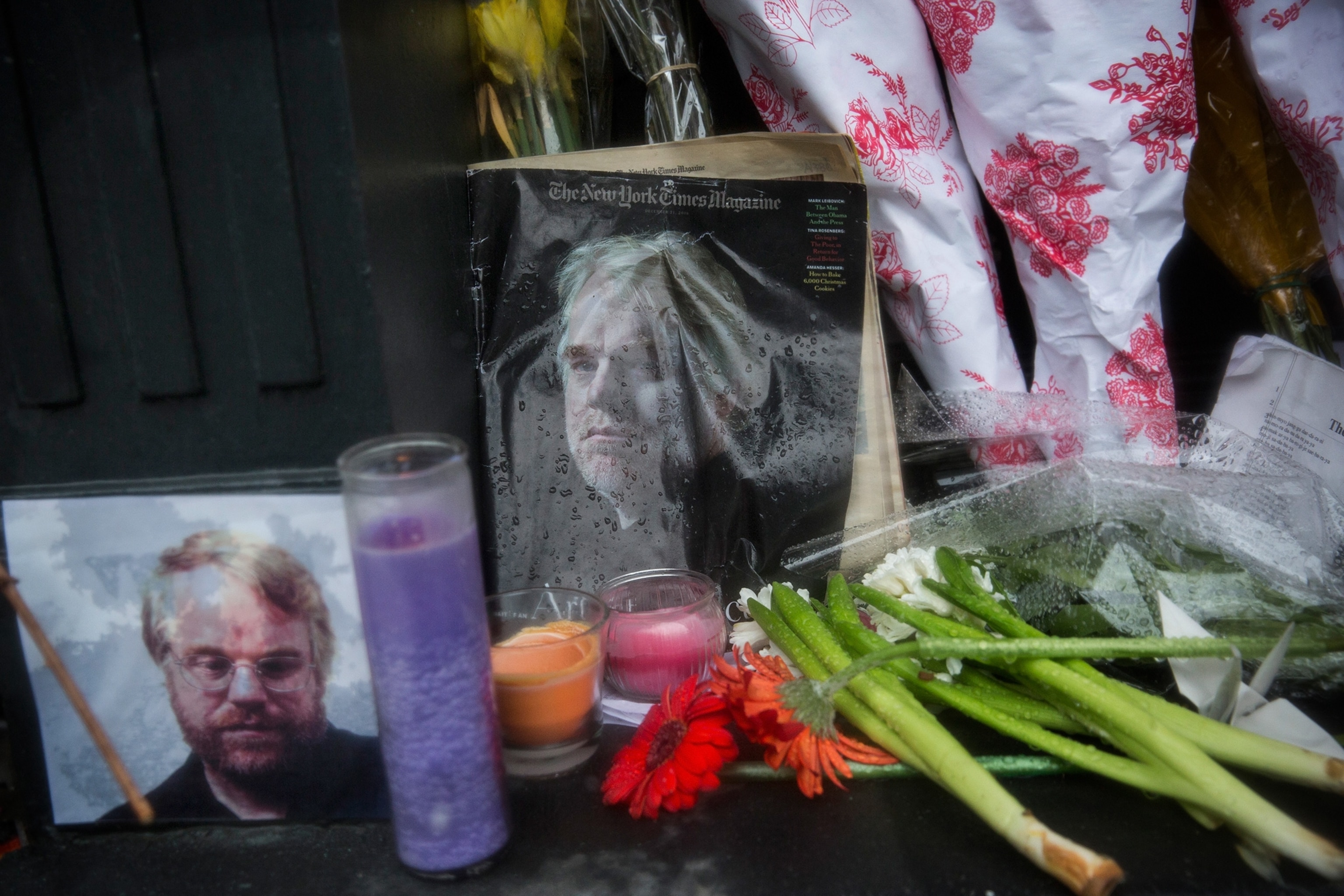 A vigil of candles, flowers and portraits sits outside the apartment of actor Phillip Seymour Hoffman.