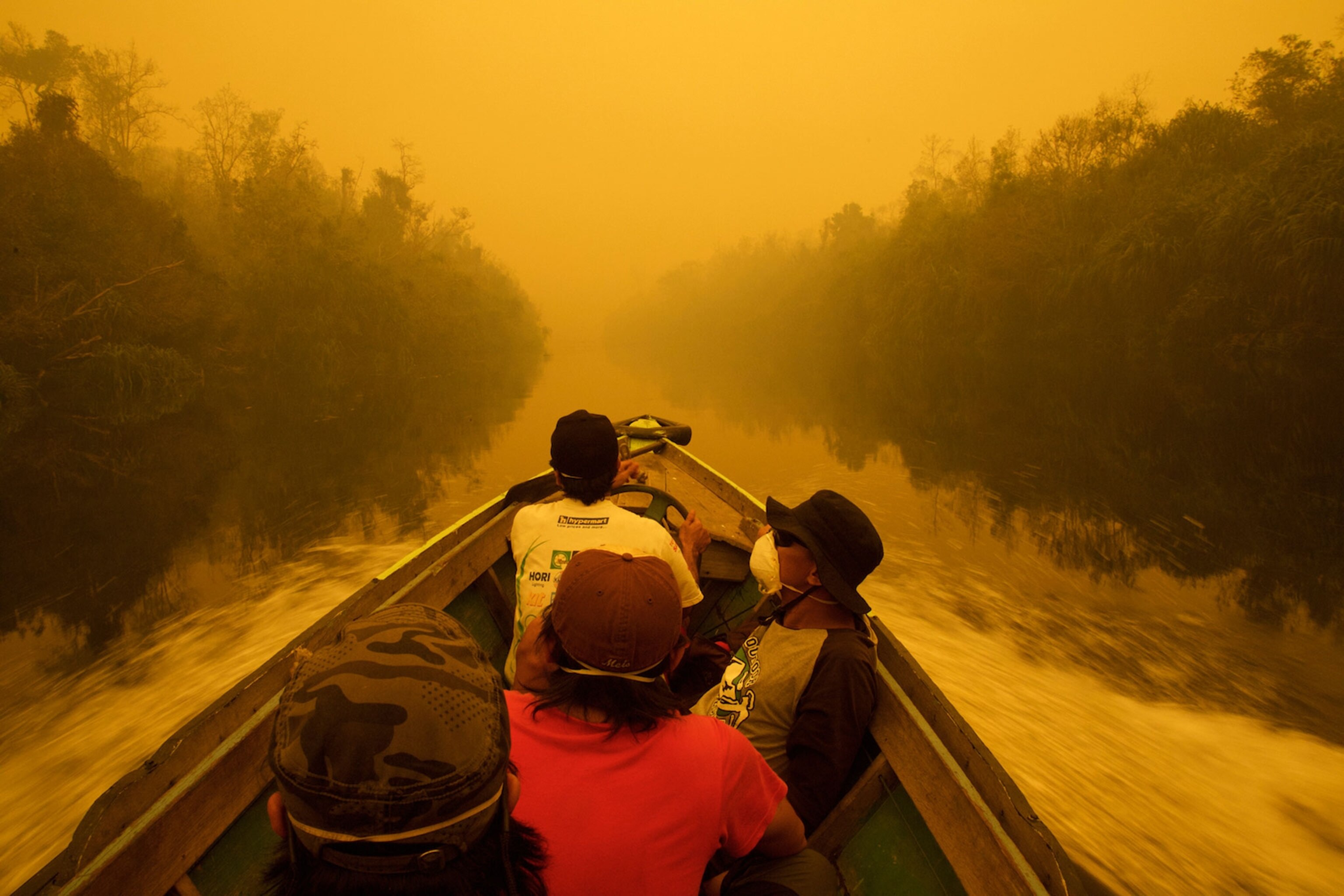 the Mangkutup River through thick smoke from forest fires