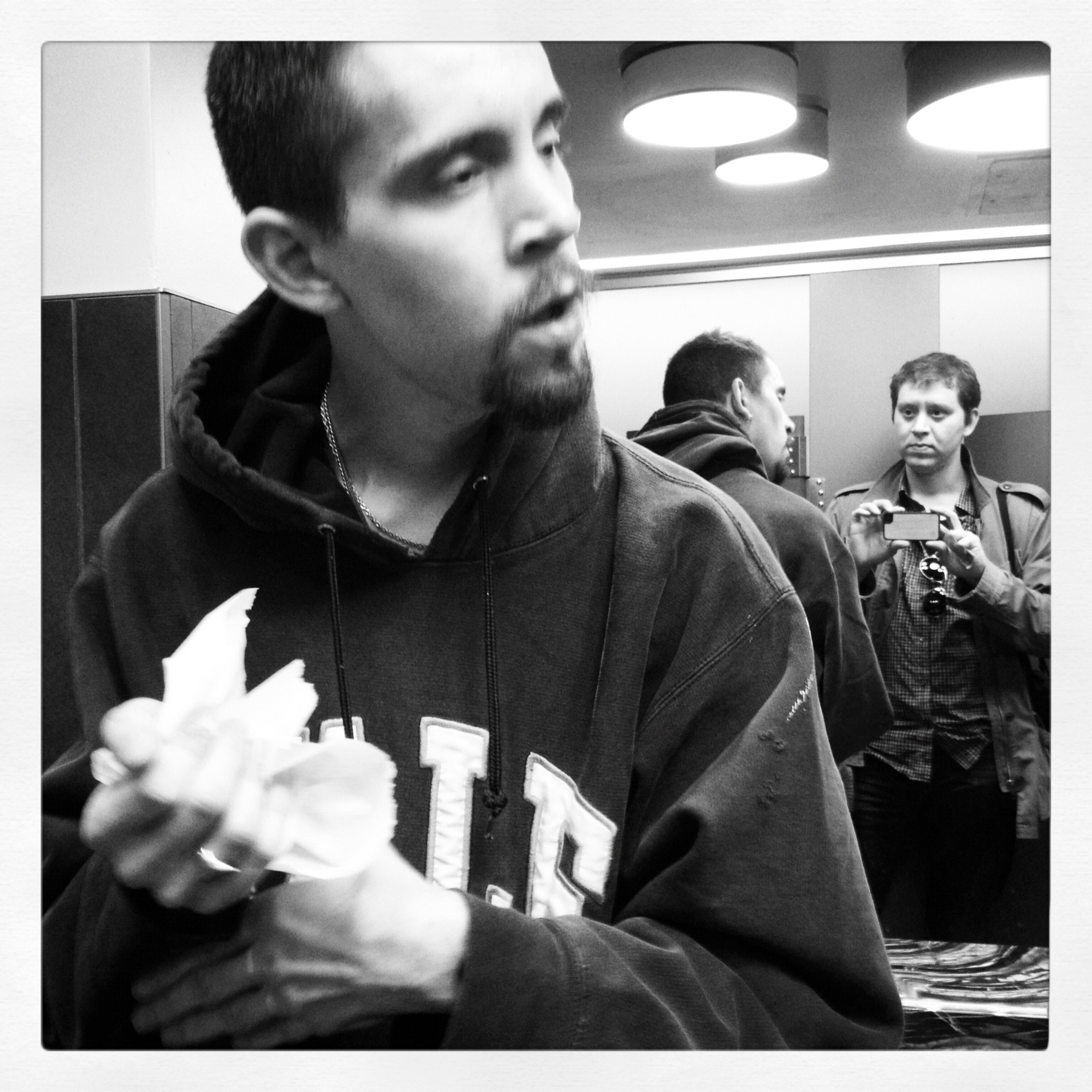 Chris photographing Nick, with his own reflection revealed in the mirror