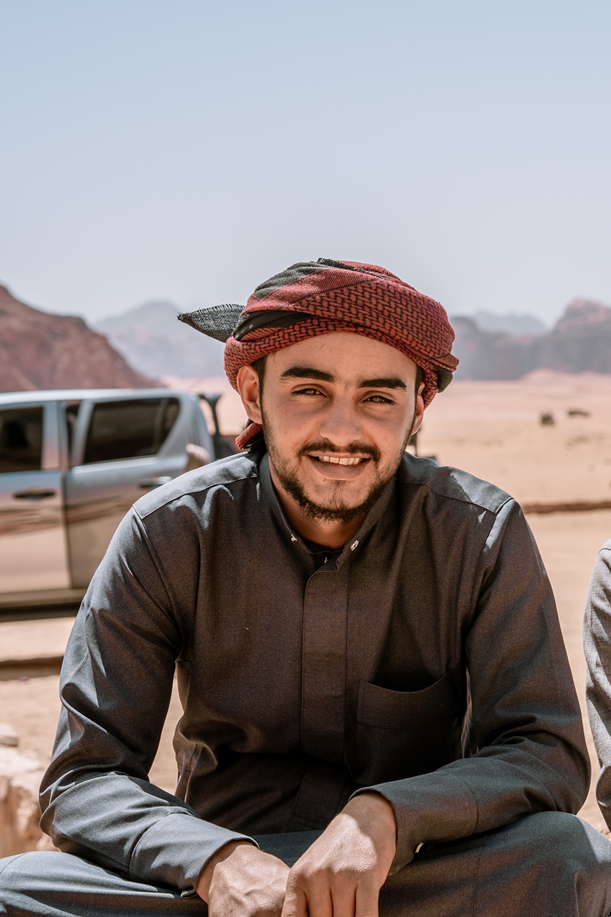 A portrait shot of a Jordanian young man in the desert.
