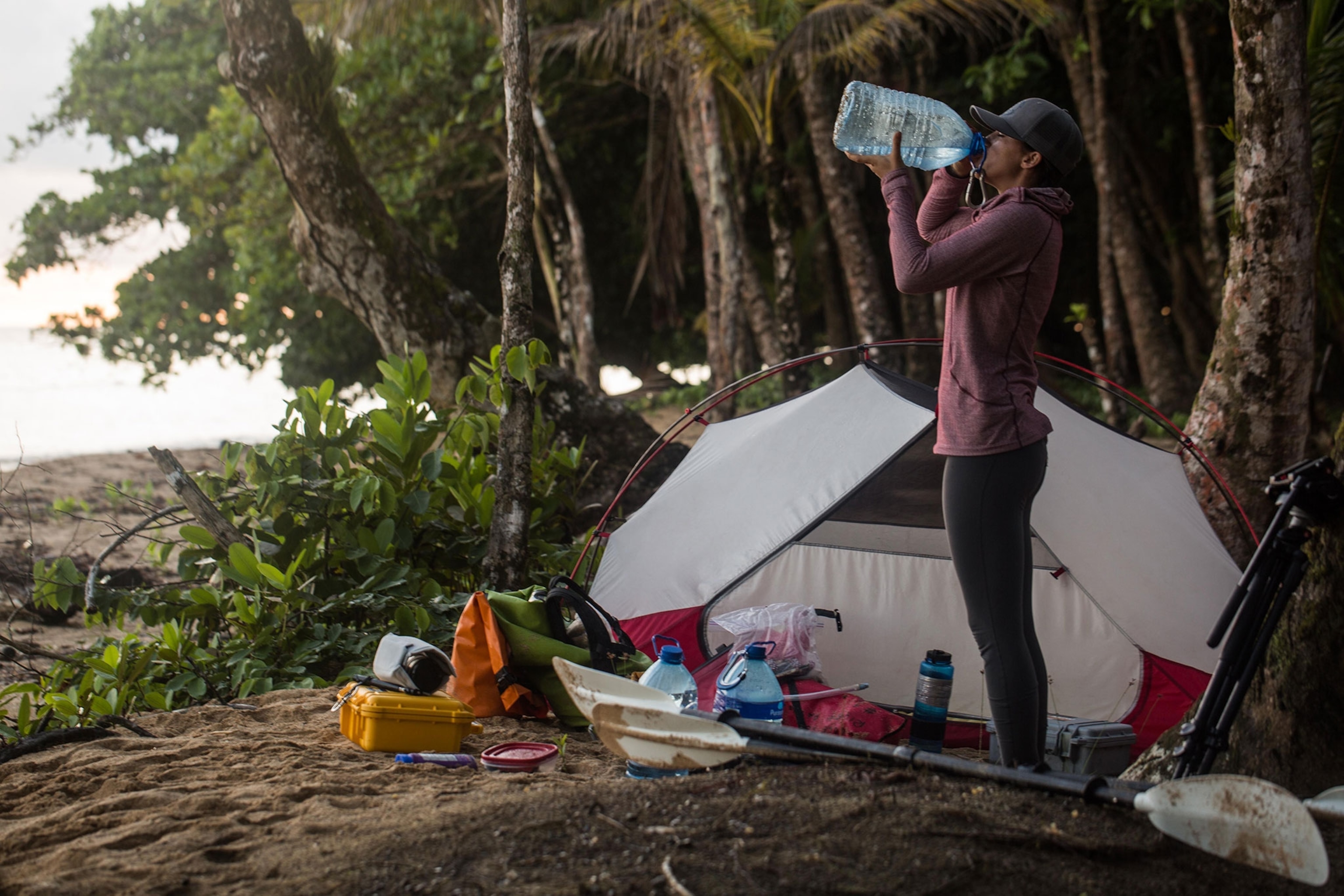 Clare Fieseler drinking water at her camp site in Panama