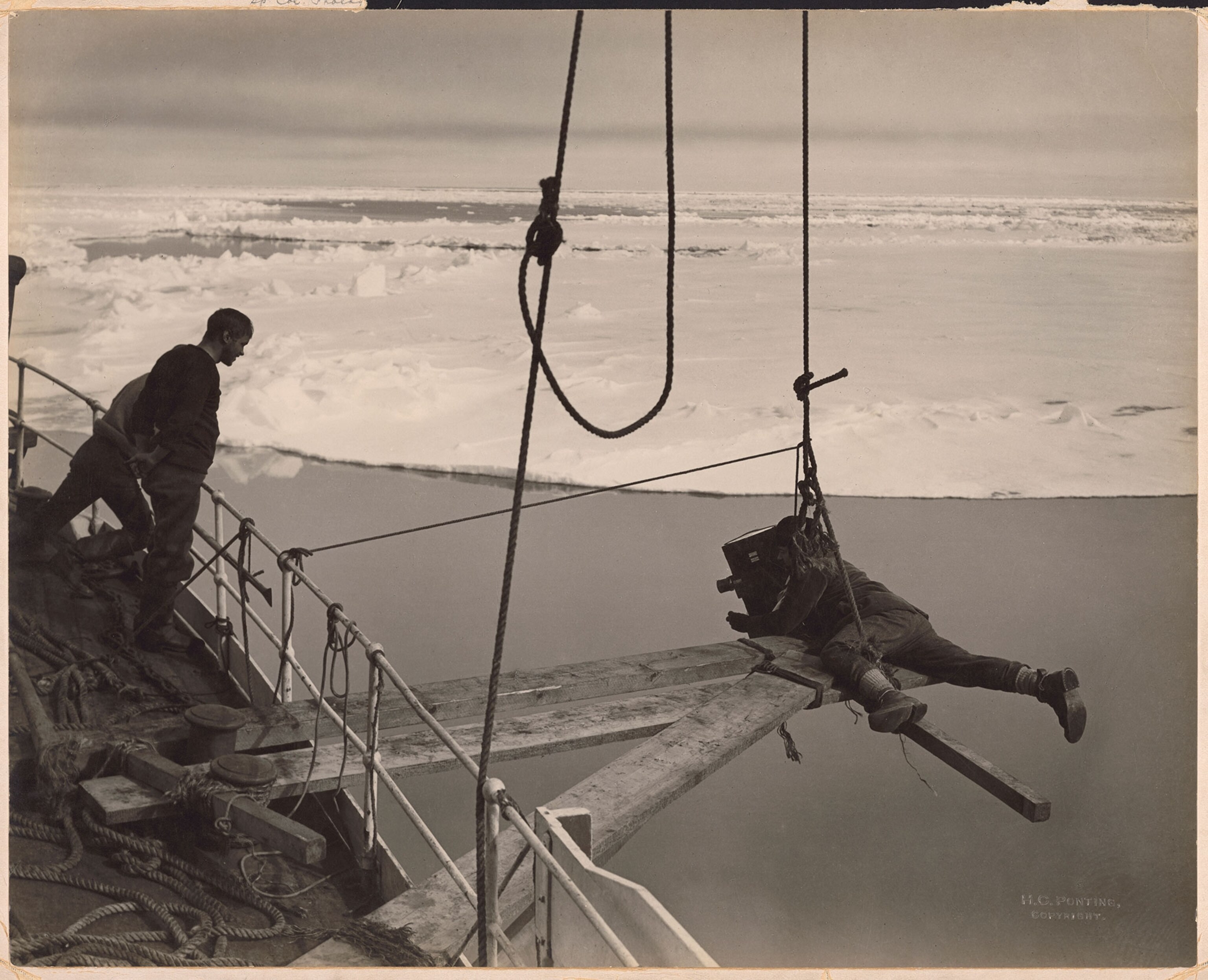 a cinematographer on the bow of a ship.