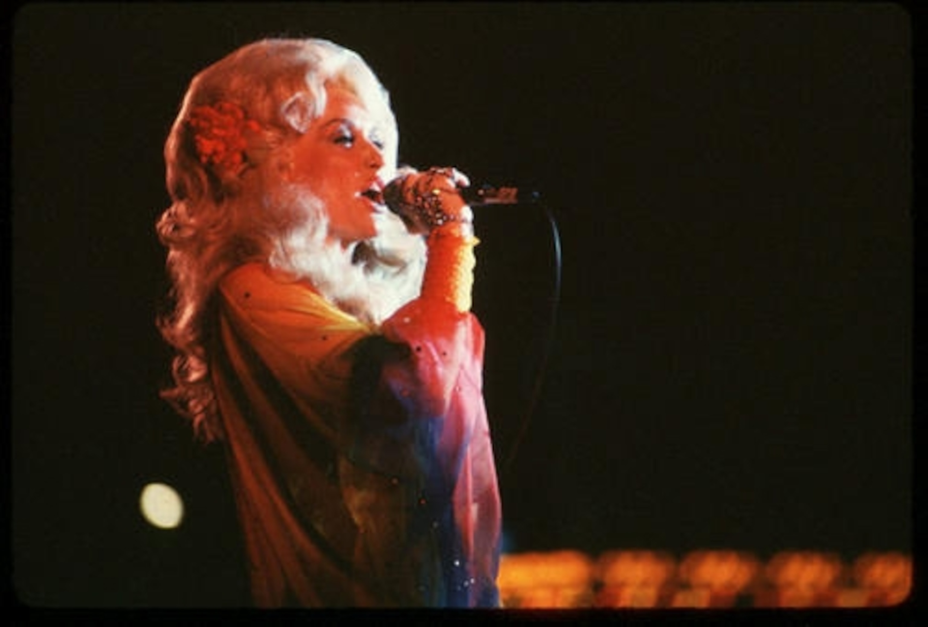 Country singer Dolly Parton performs on stage.