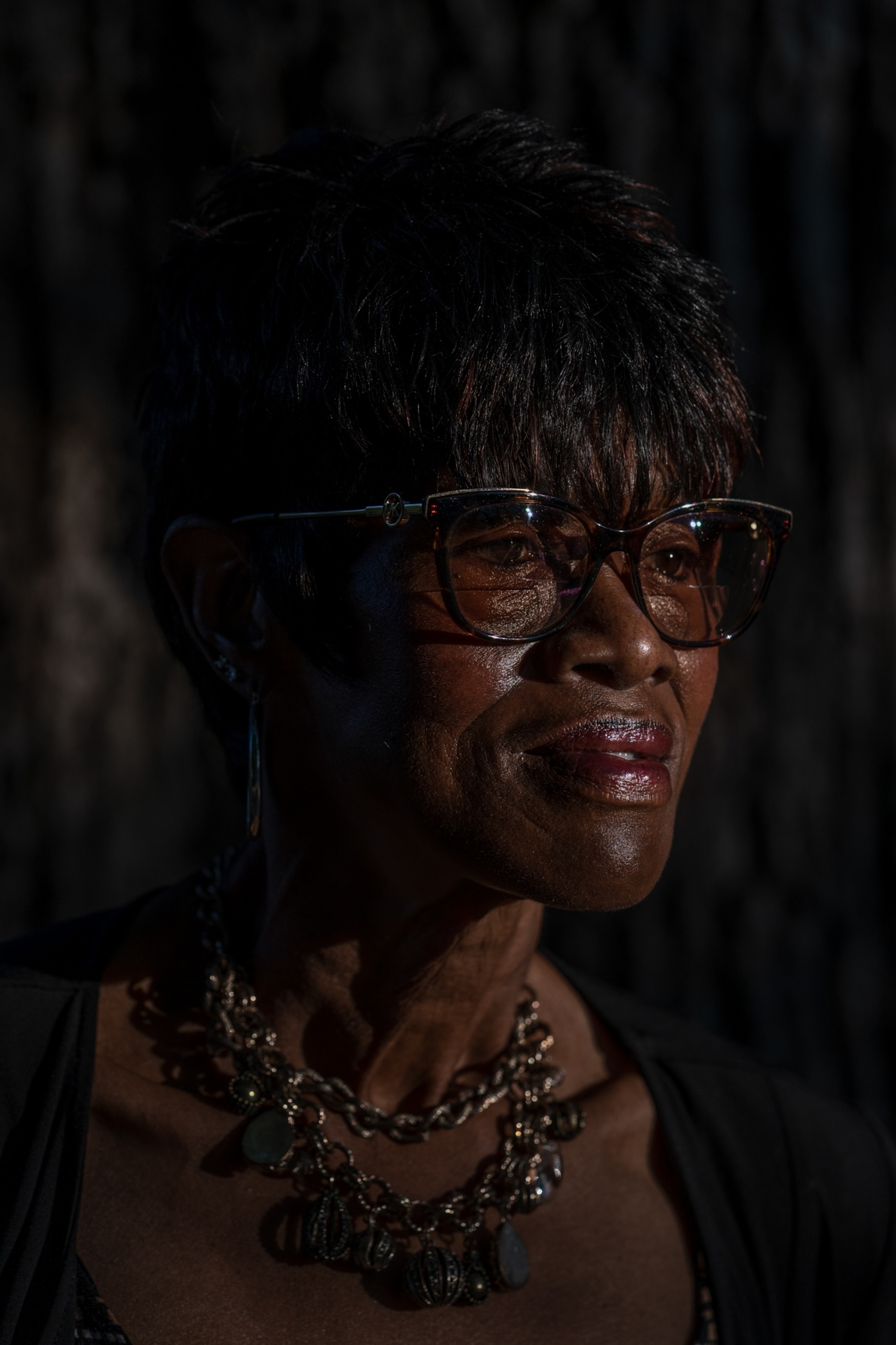 a woman poses for a portrait outside