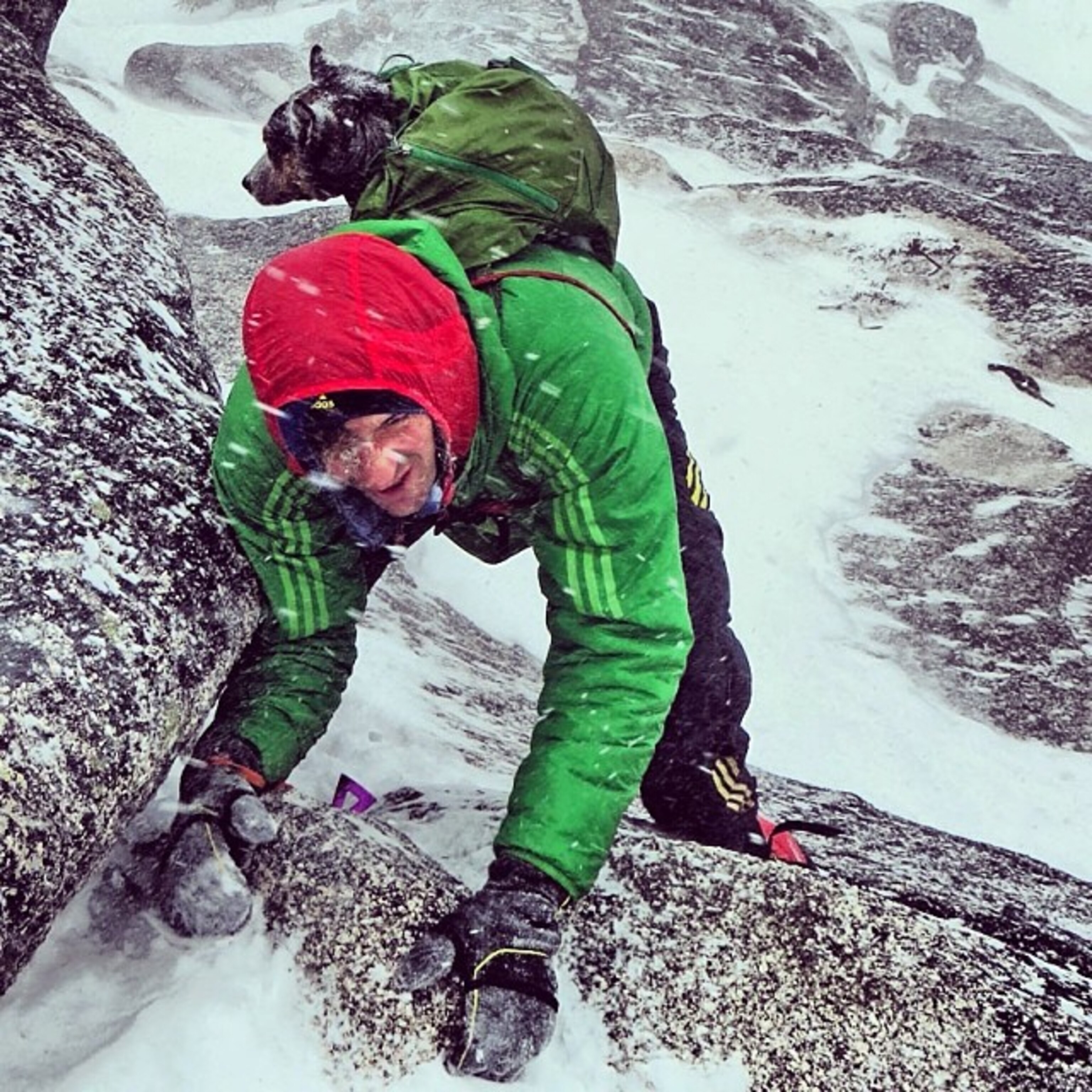 Dean Potter climbing in snow with his dog