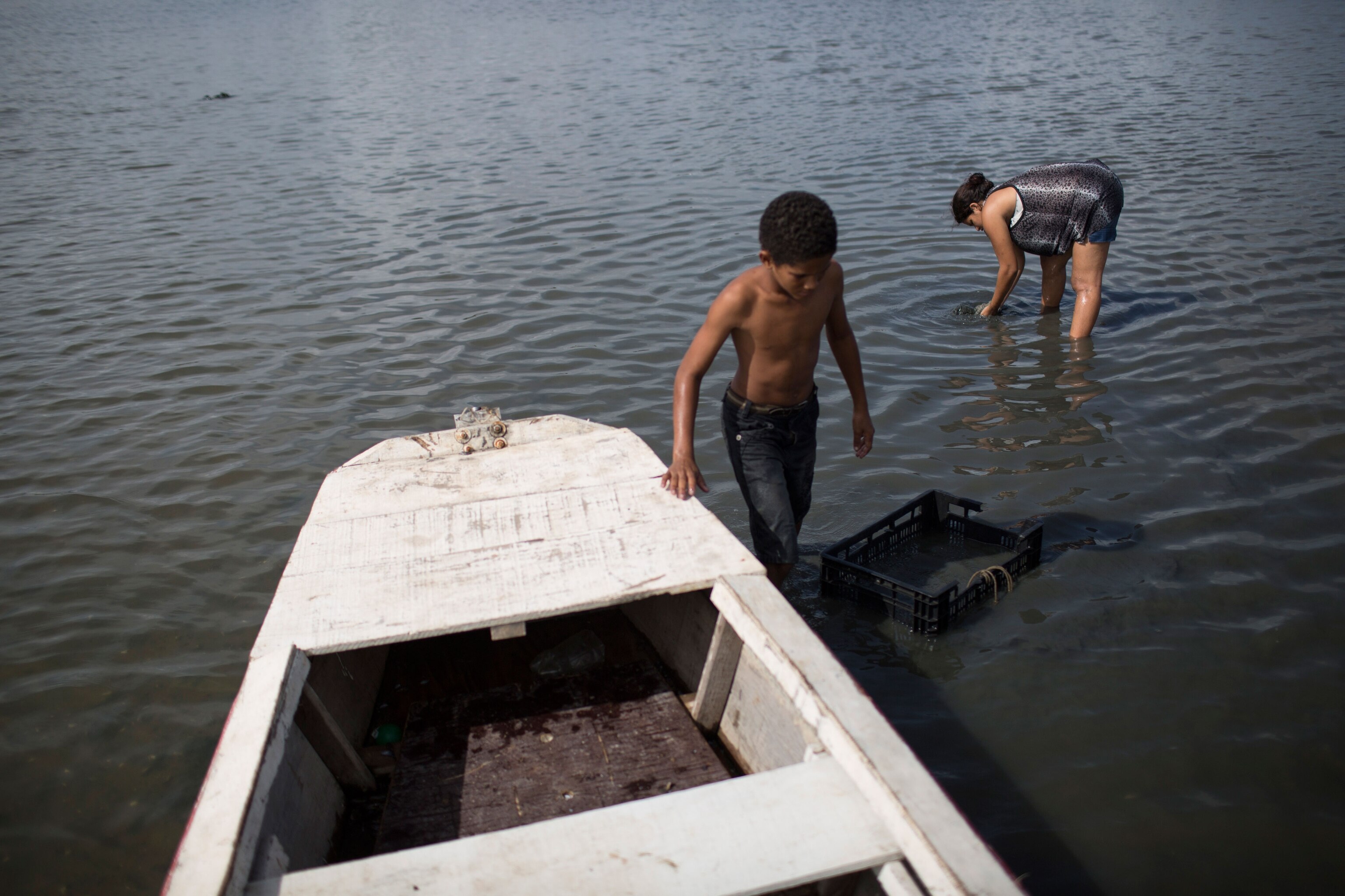 people in a river in Recife, Brazil