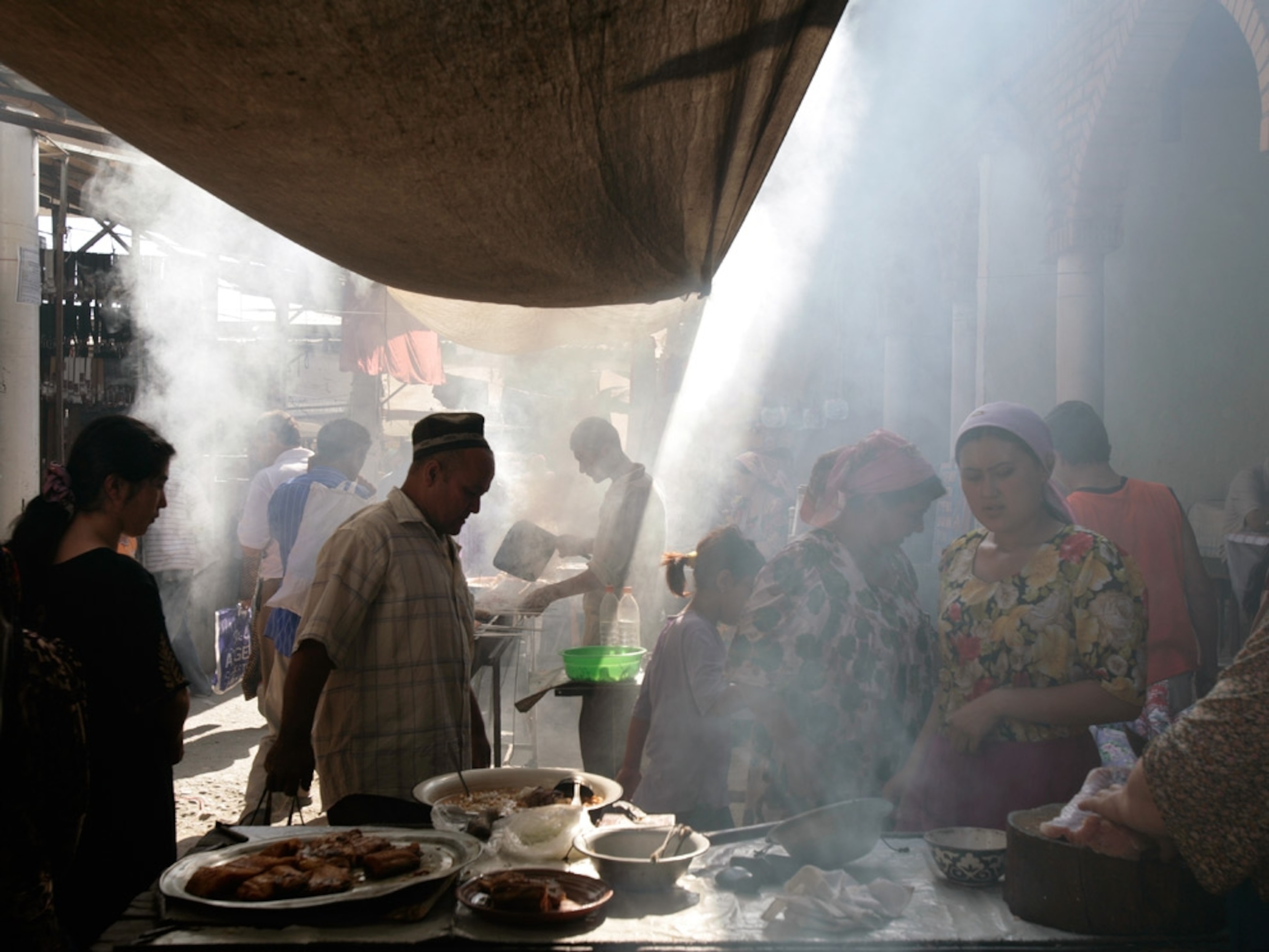 Food stalls in a smoke-filled alley