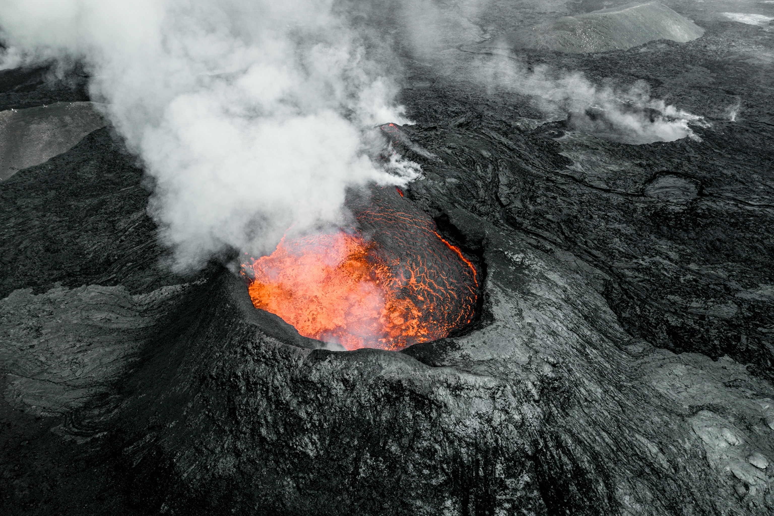 A volcano with pulsating lava at its centre, shot from above