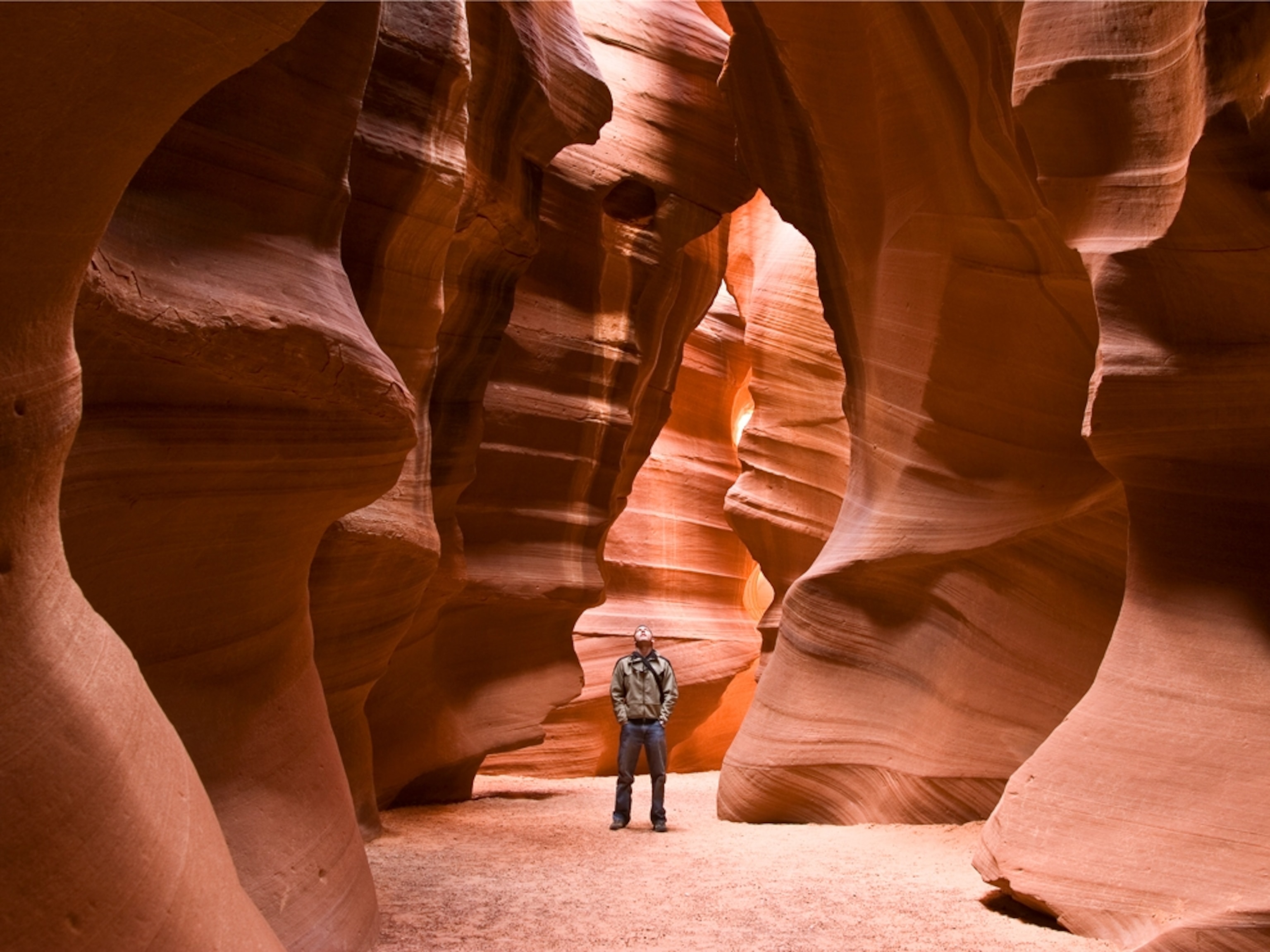Man standing in light in Antelope Canyon