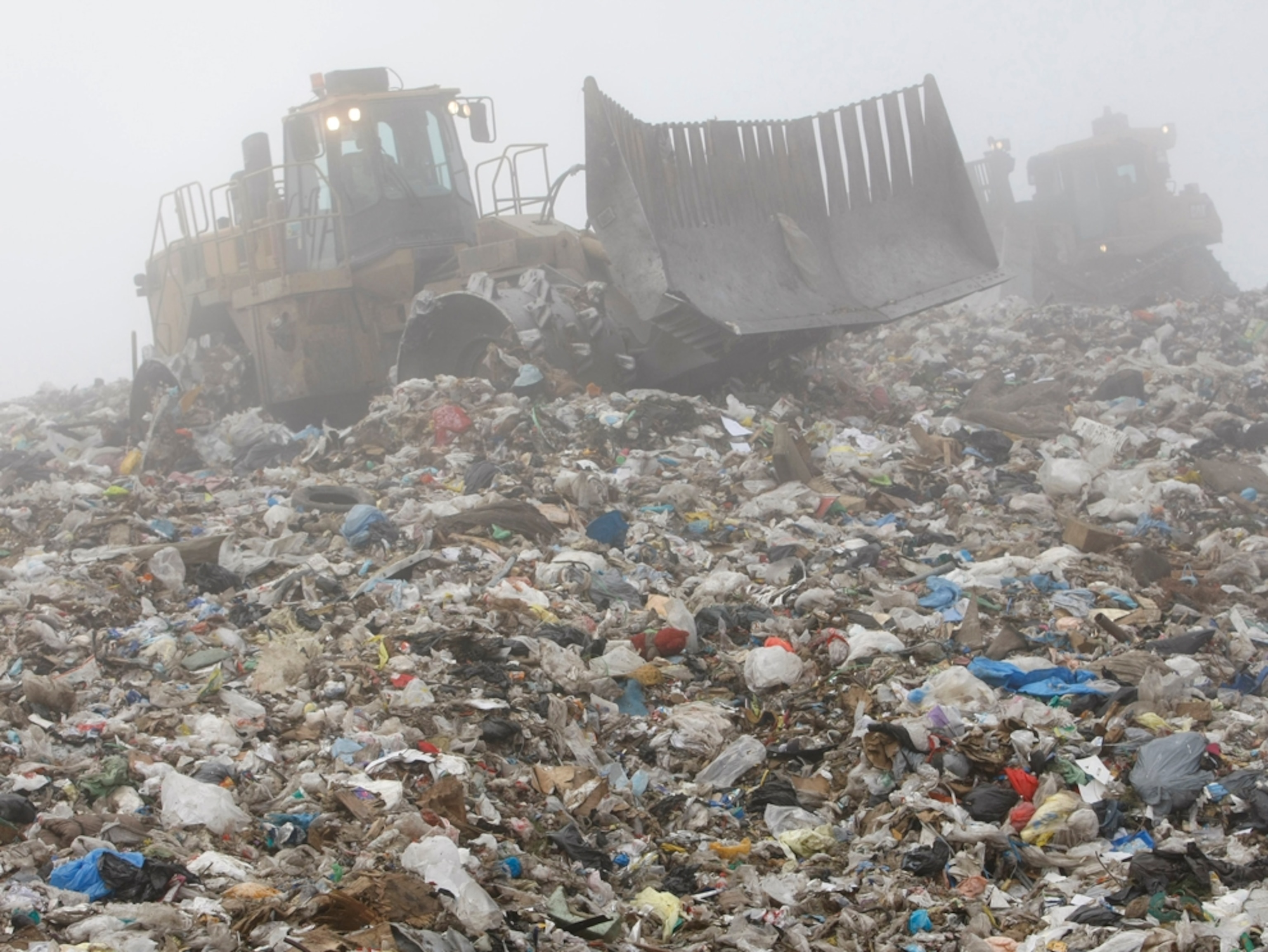 Tractor sorting garbage in a landfill