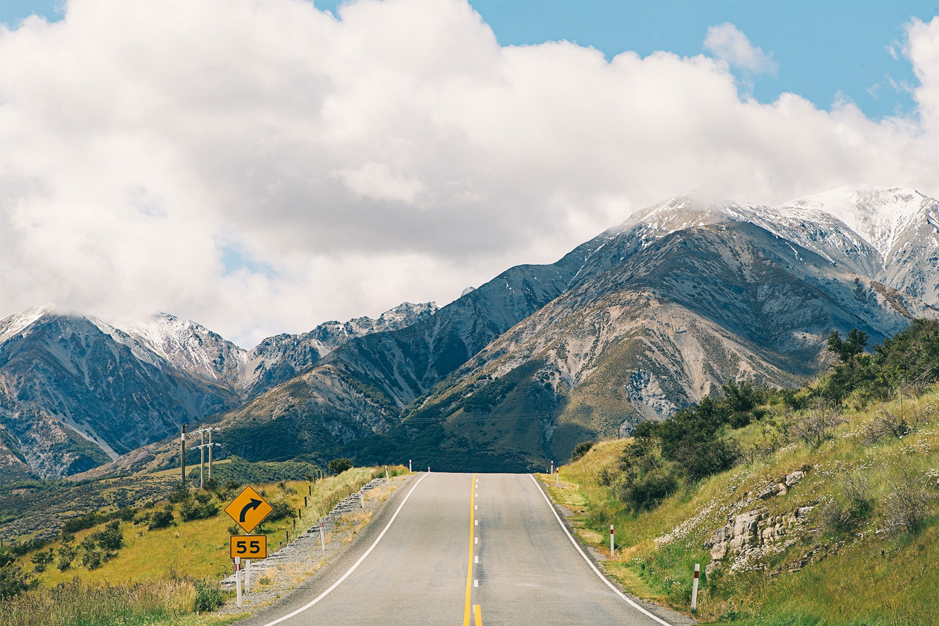 an empty road over a hill