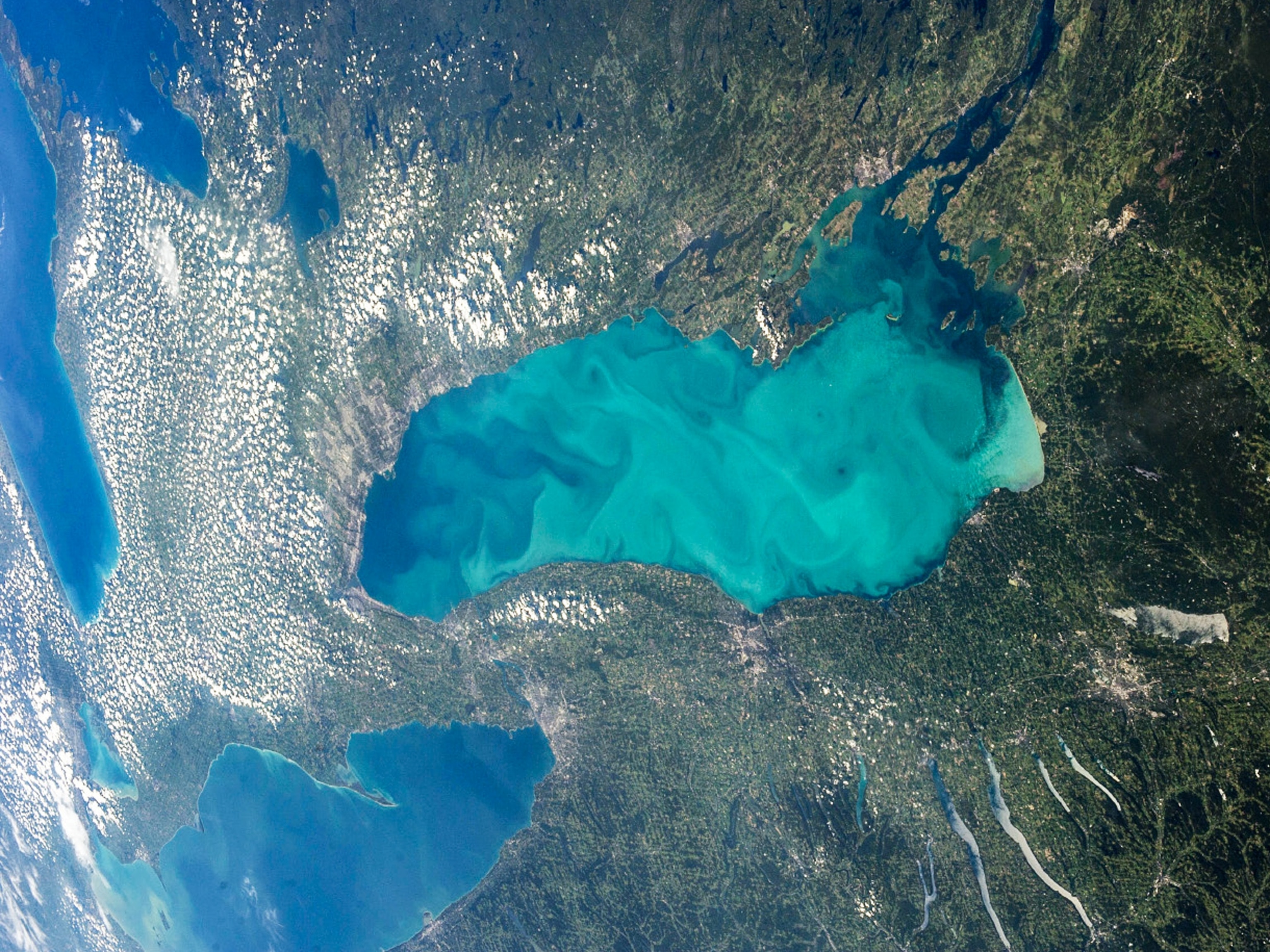 Lake Ontario coated with milky swirls taken from International Space Station.