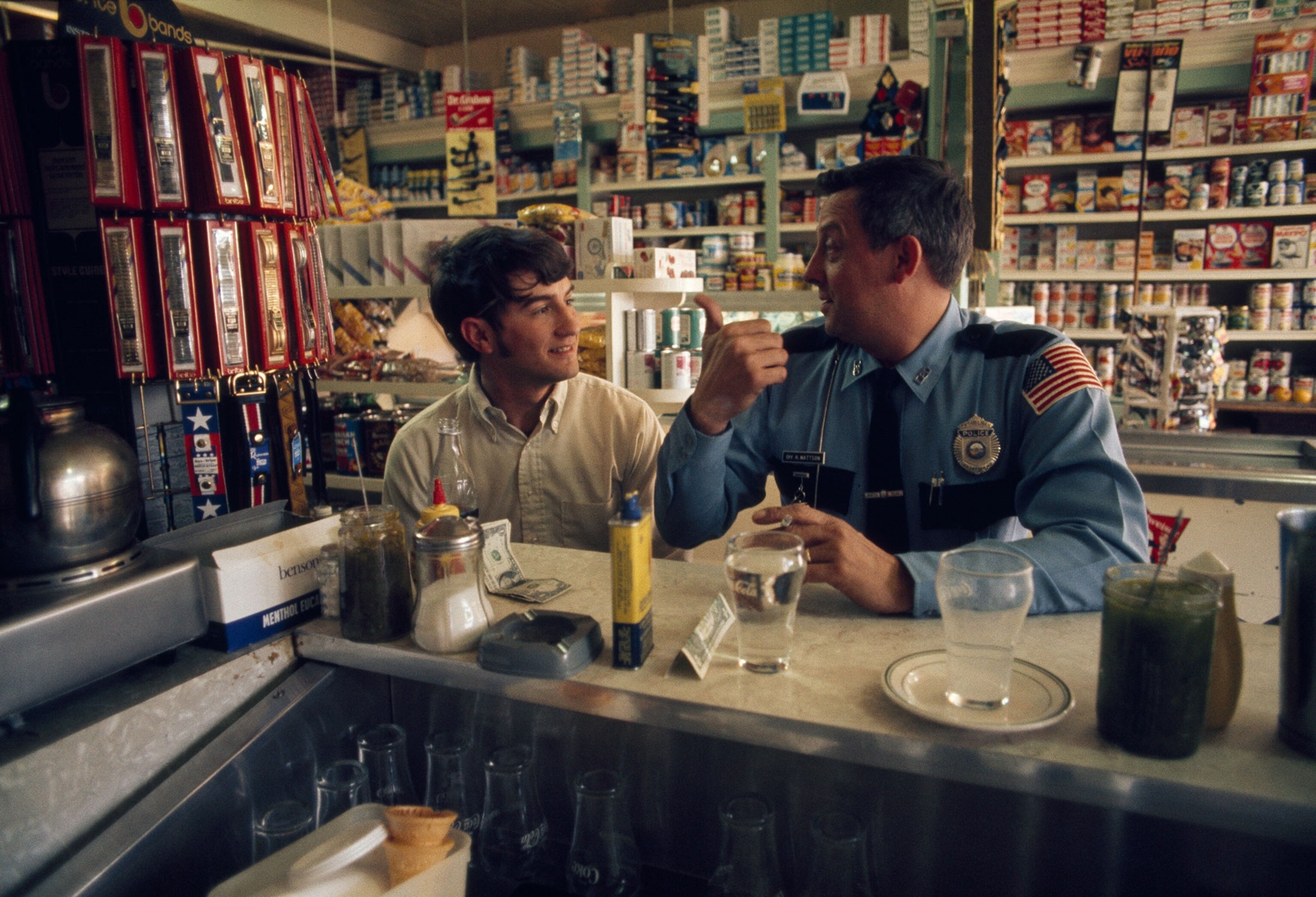 a local policeman talking to a local boy at the town diner