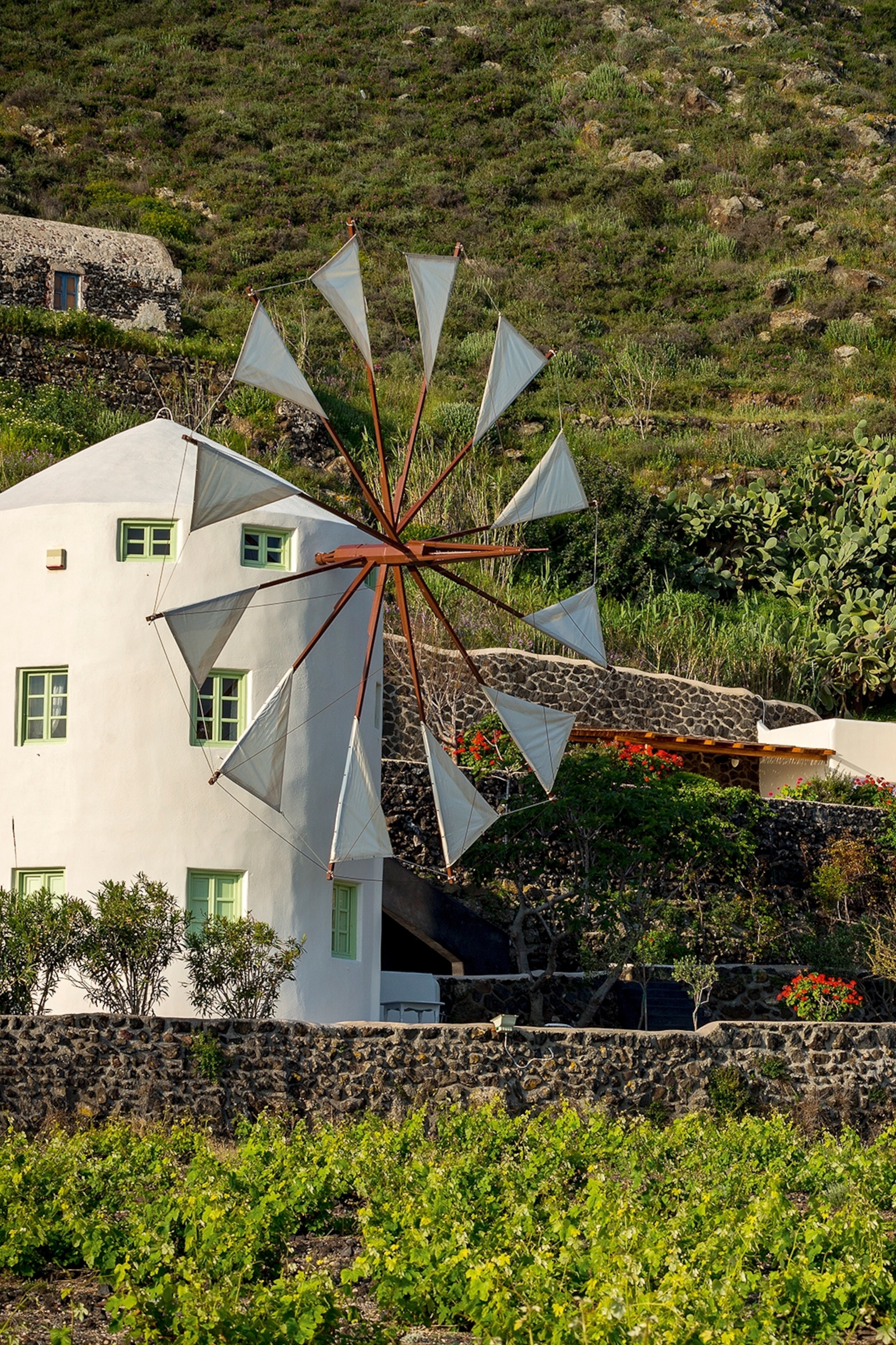 A hill-side hotel estate with multiple windmill villas.