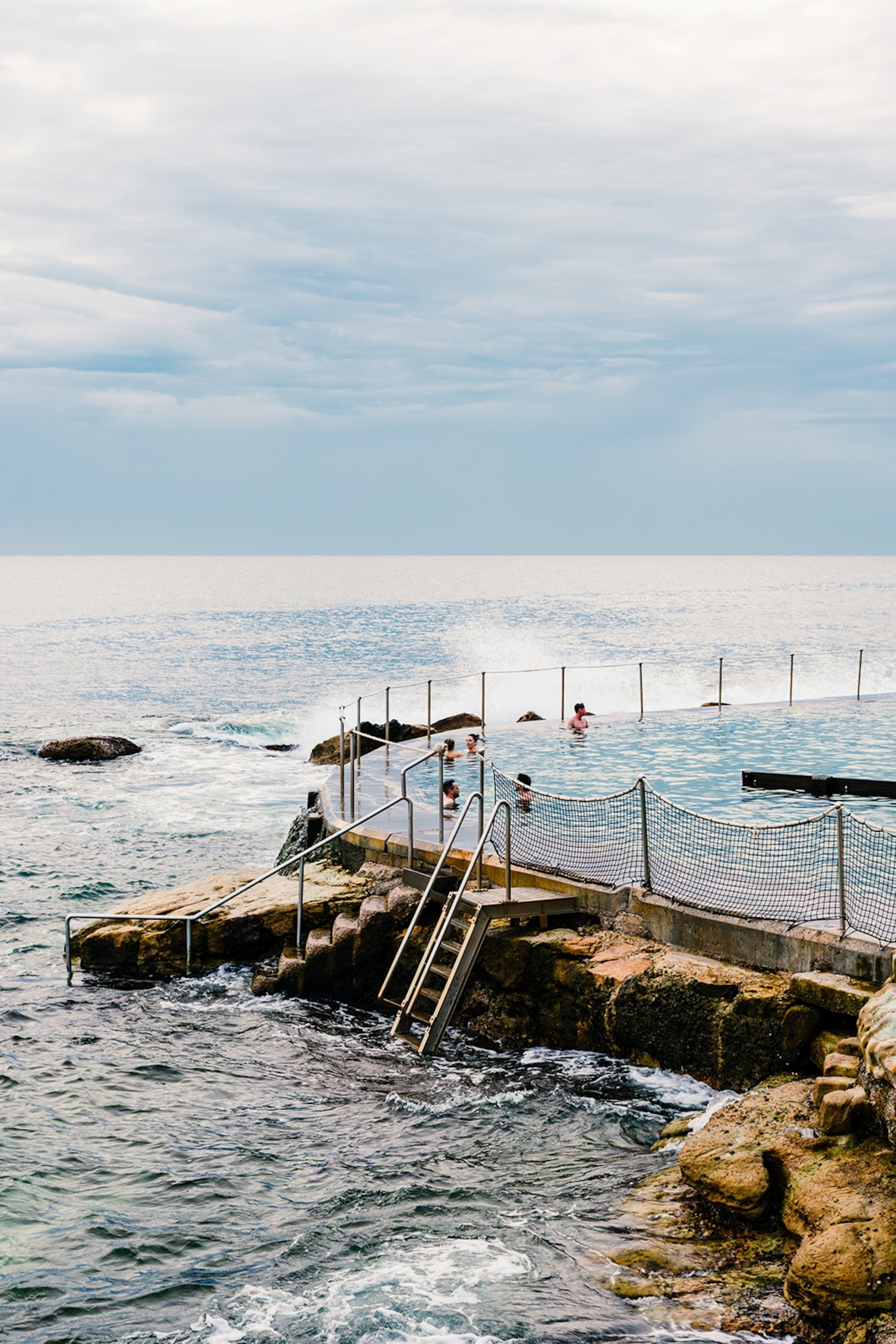A natural pool separated from the ocean only by a wall of natural rocks.