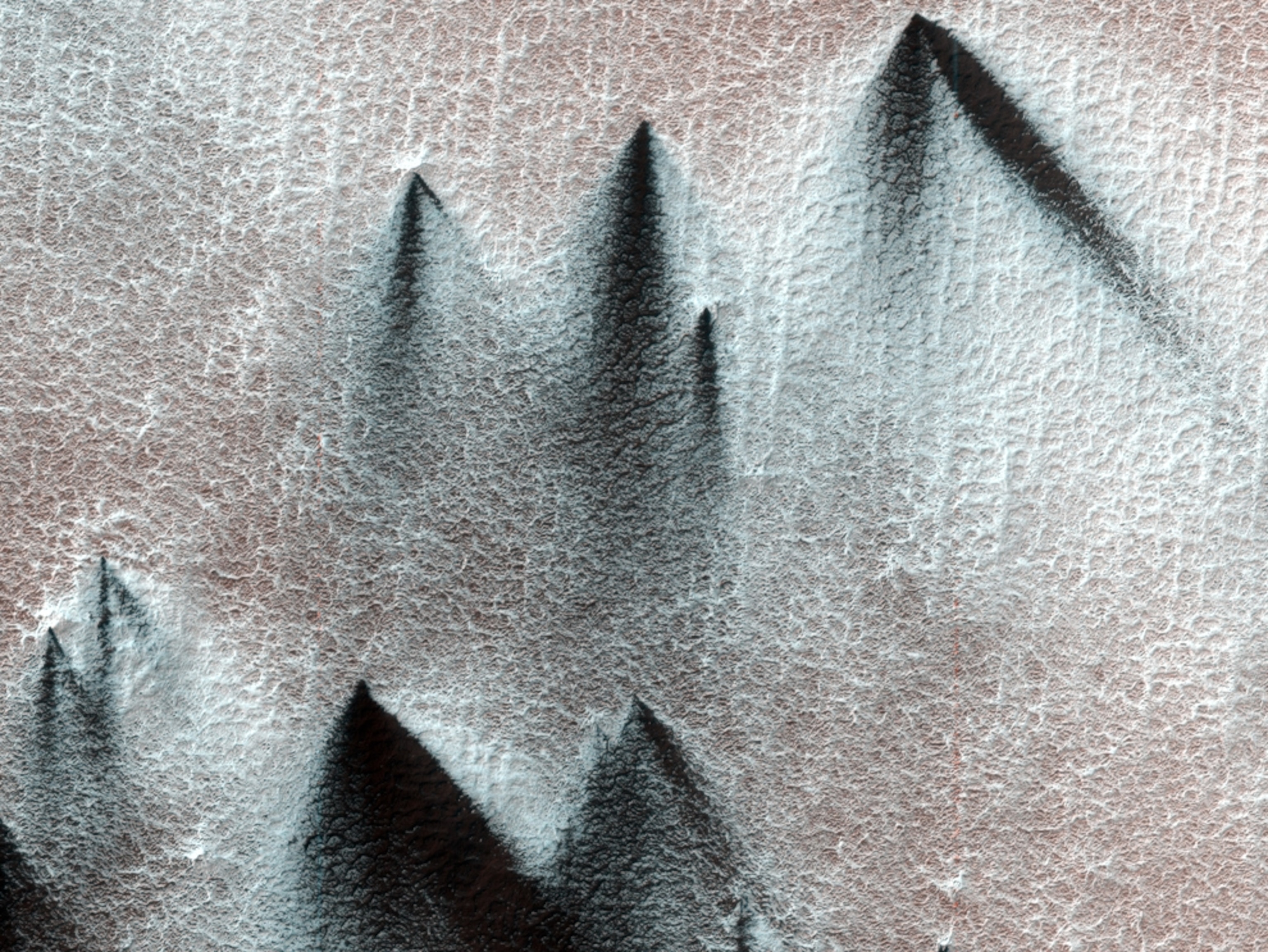 Satellite picture of fans of dark material blown across Mars's surface.