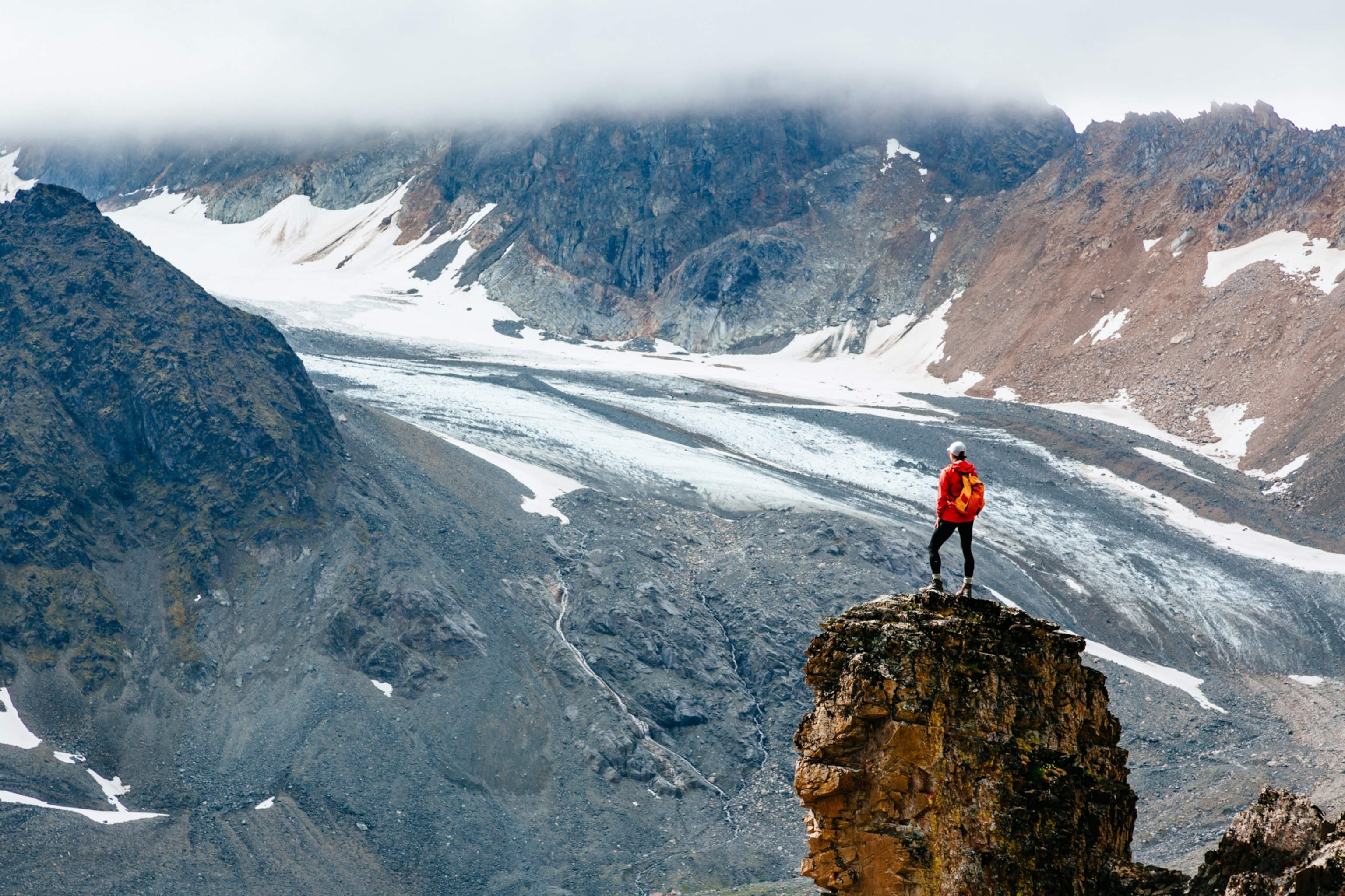 A woman takes in the view on a hike in Lake Clark National Park and Preserve, Alaska, USA
