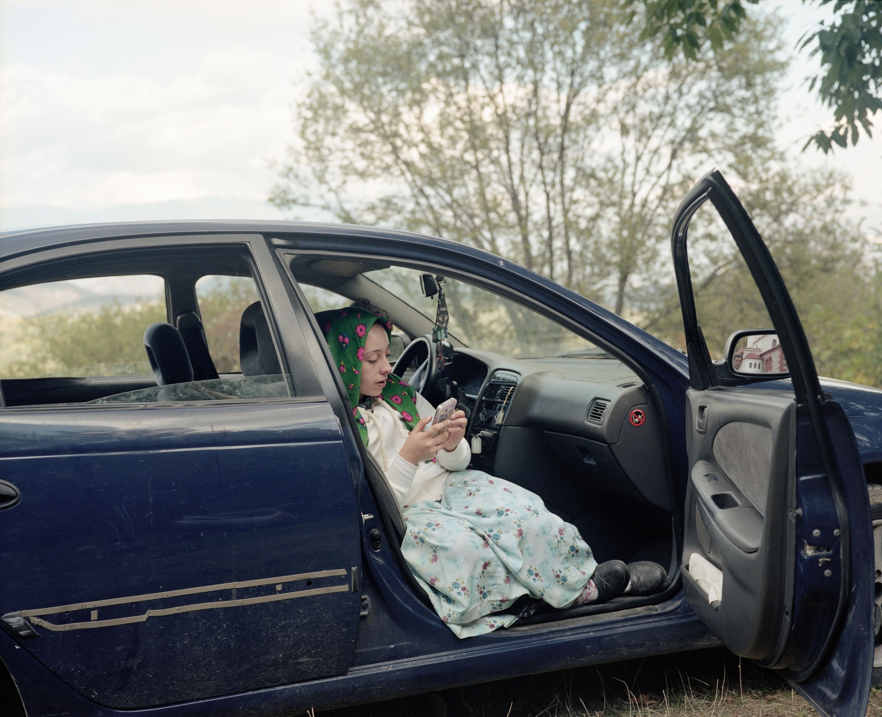a Pomak girl on her phone in Greece