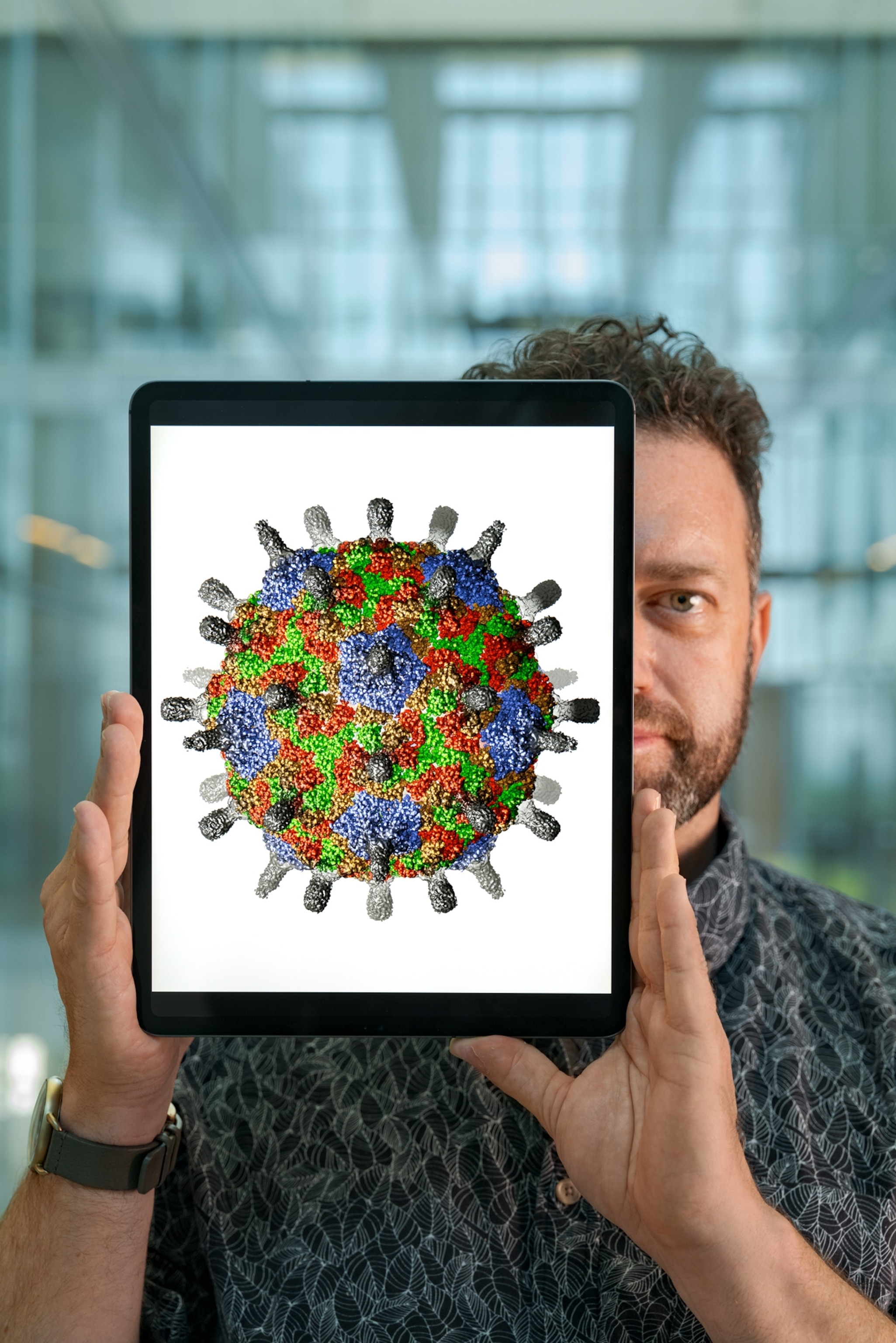 man holding photograph of capsule.