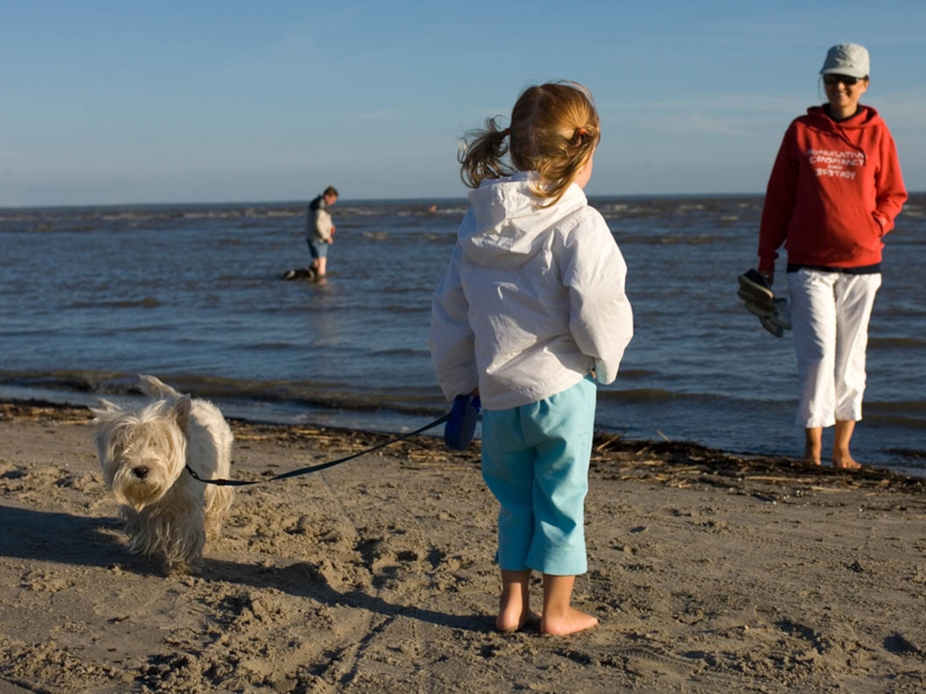 Girl, mother, dog at Parnu Beach, Estonia