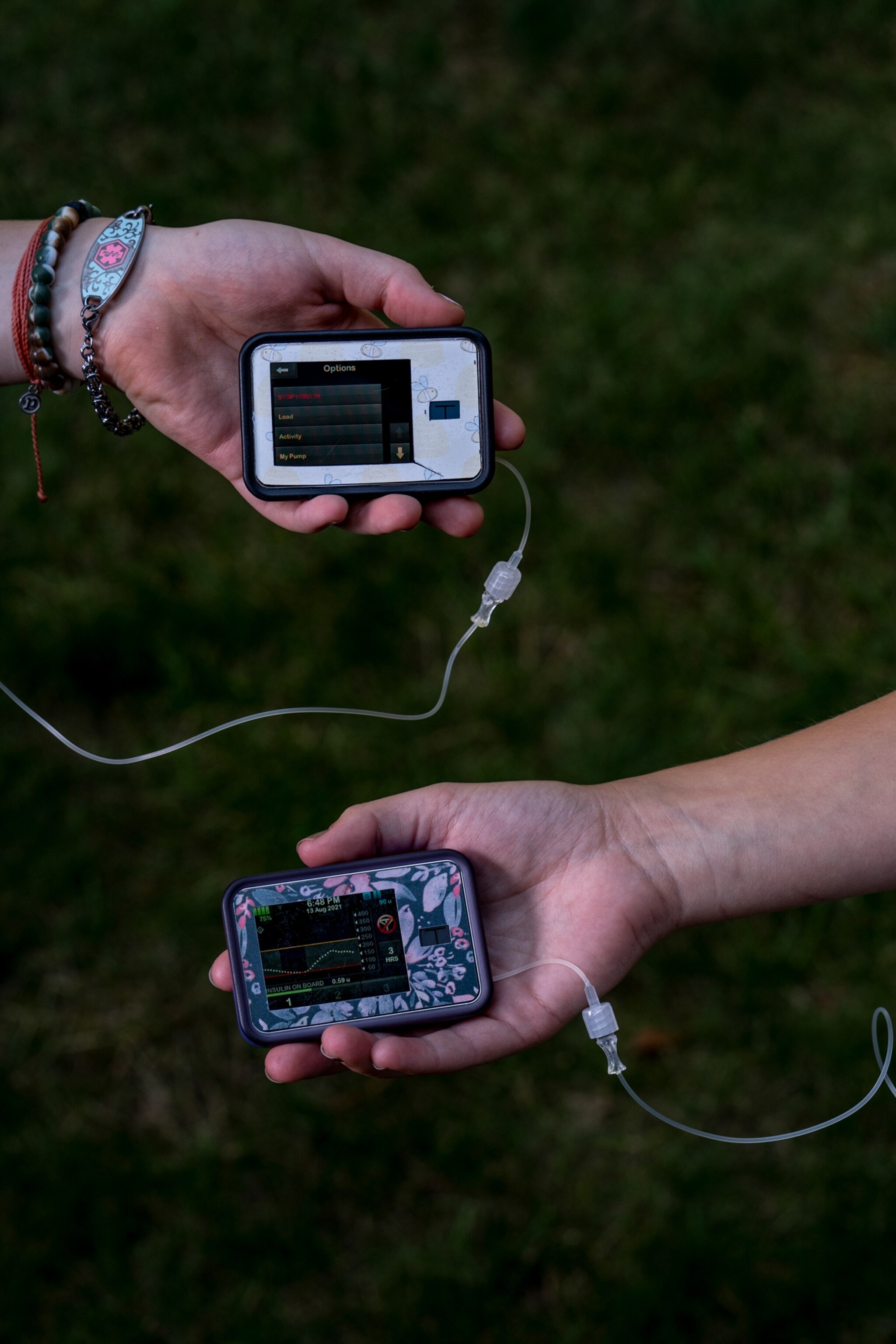two continuous glucose monitors in the grass